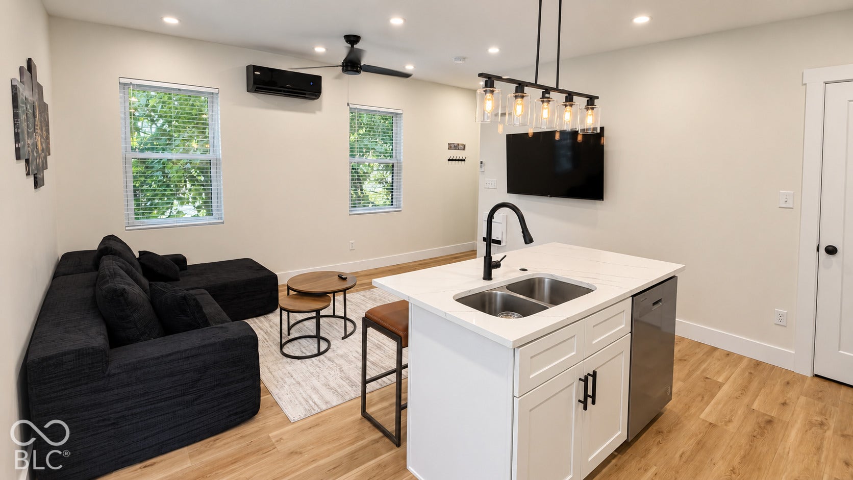 Open concept living area featuring wood-finish flooring, recessed lighting, and a ceiling fan