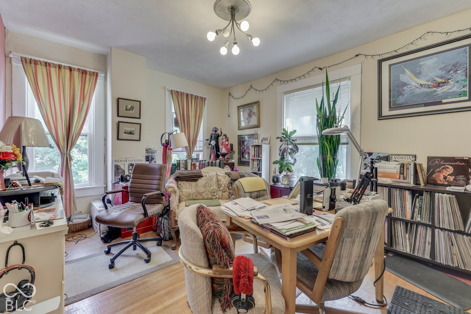 Unit 4 Recessed lighting fixture, light wood-finish flooring, multiple windows, and built-in shelving