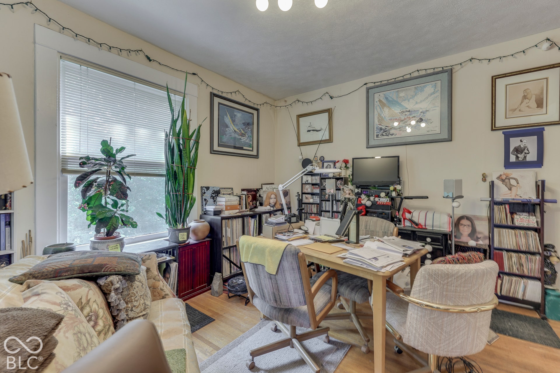Unit 4 Wood-finish flooring, white walls, and a window with blinds provide natural light