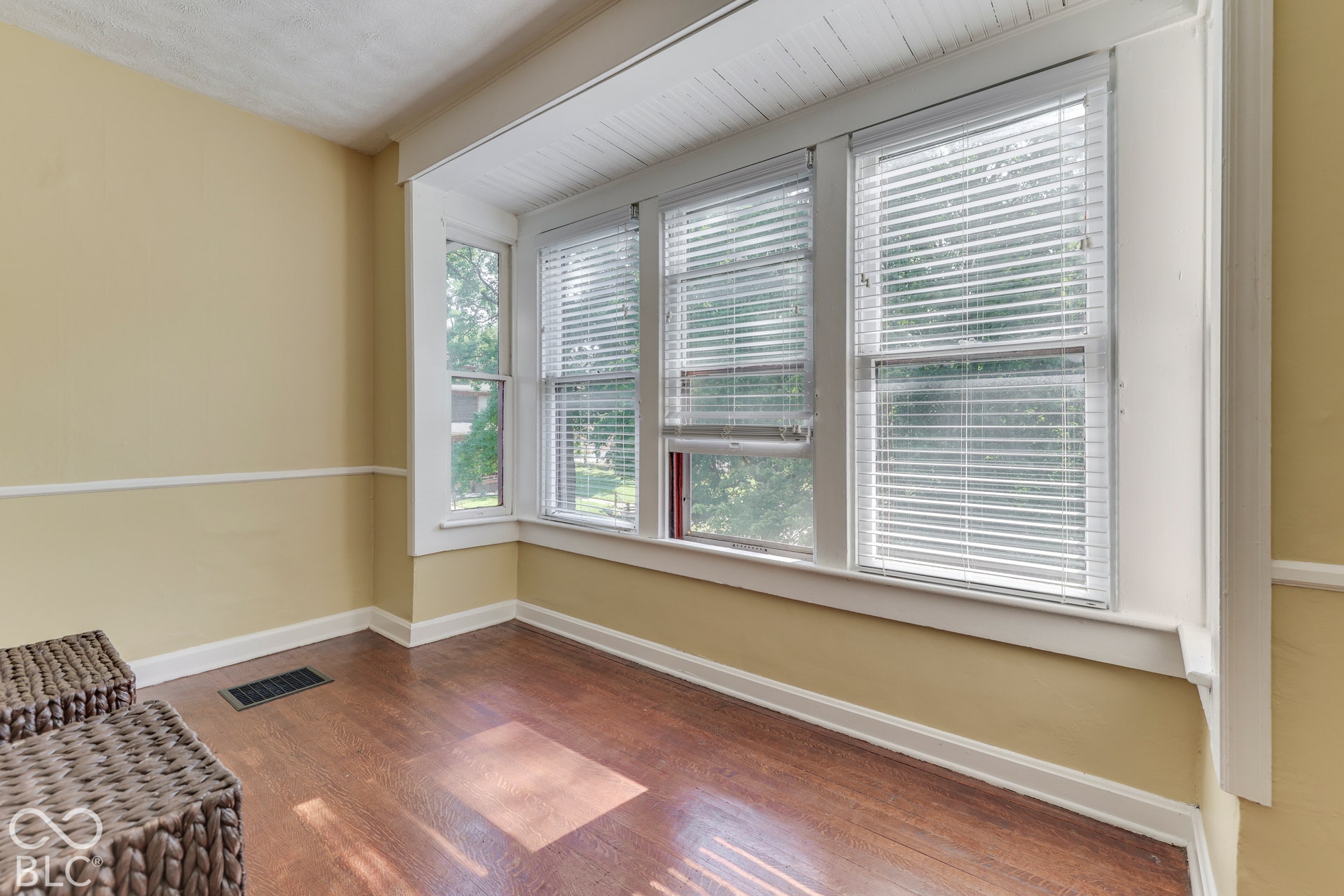 Unit 3 Bay window with multiple windows, wood-finish flooring, and crown molding