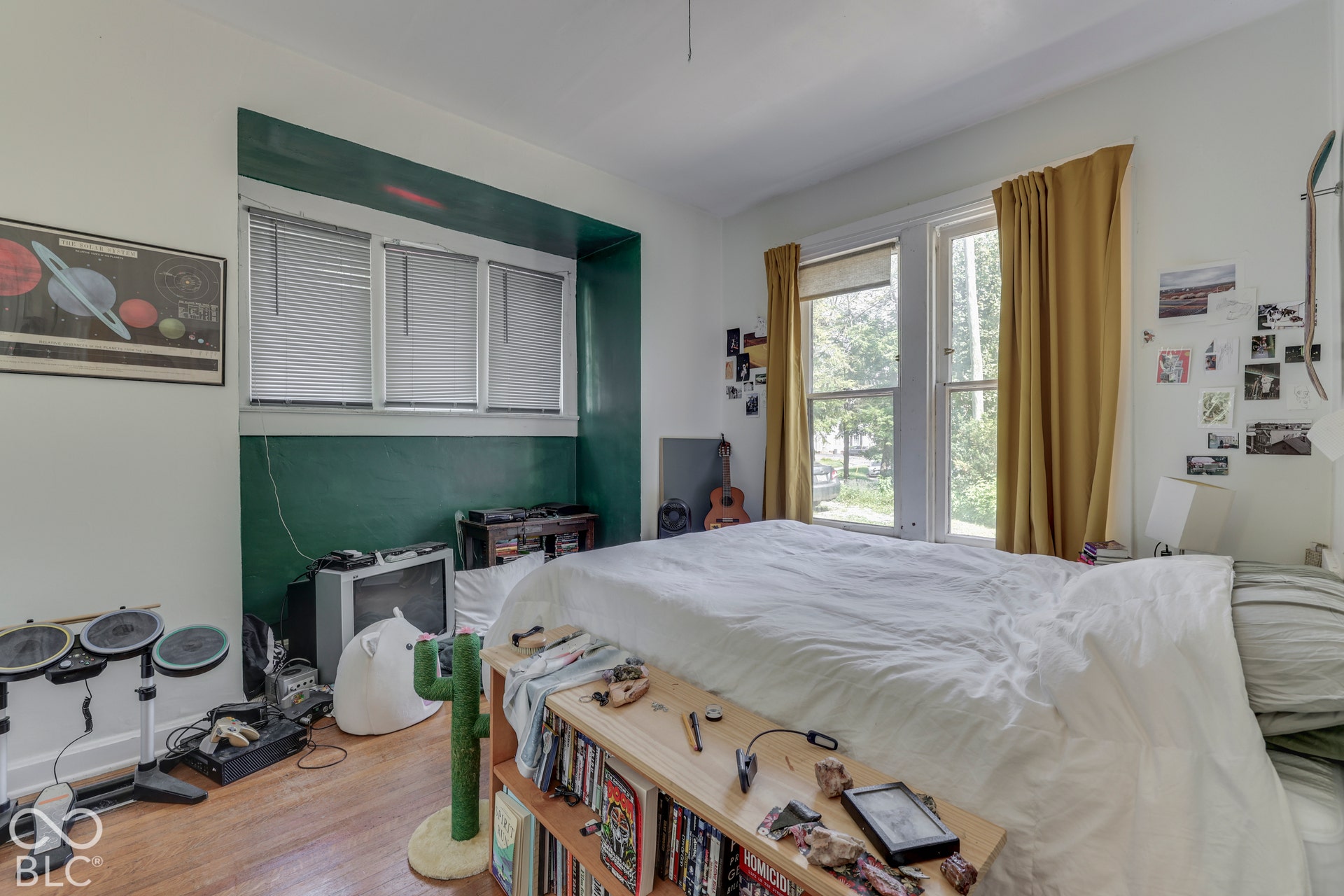 Unit 2 Hardwood flooring, multiple windows with blinds, recessed wall feature with accent paint