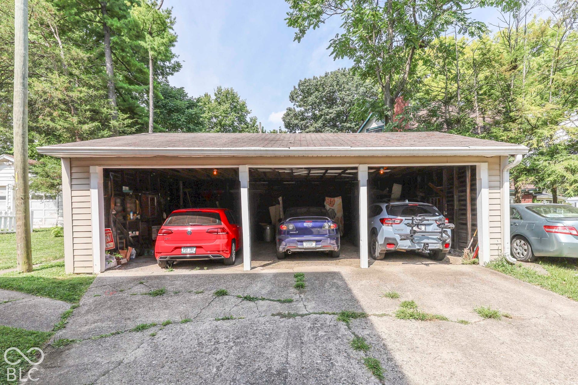 Three-bay detached carport with an uncovered 4th parking spot