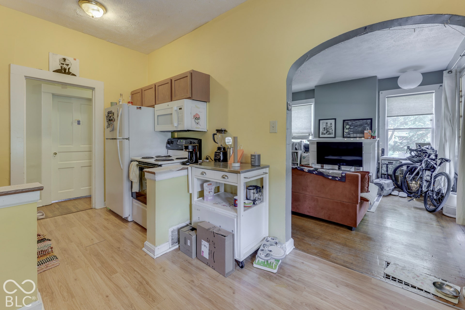 Unit 2 Wood-finish flooring throughout, with an arched doorway