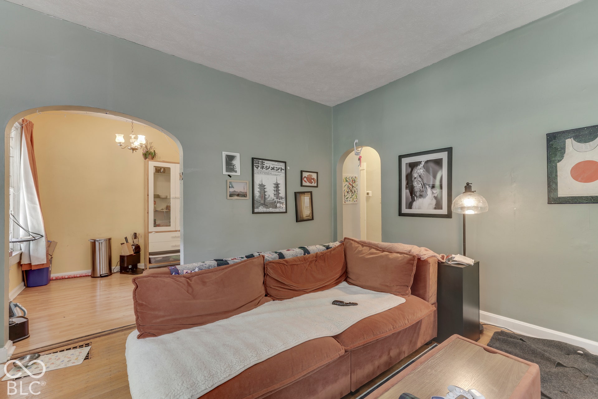 Unit 2 Arched doorways, light wood-finish flooring, and a built-in display cabinet