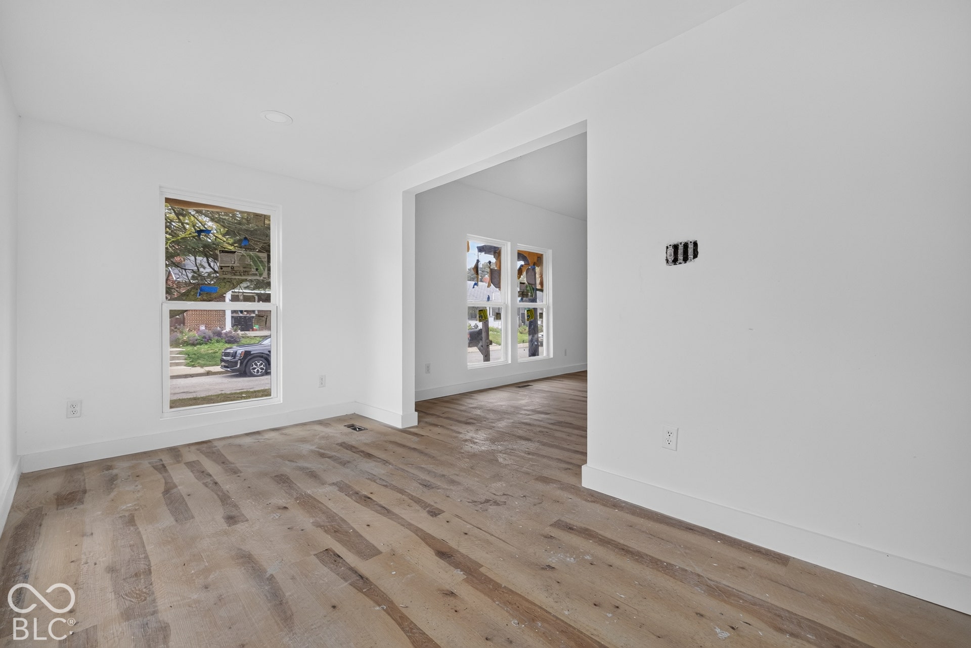 Wood-finish flooring throughout, white walls, and a recessed ceiling light