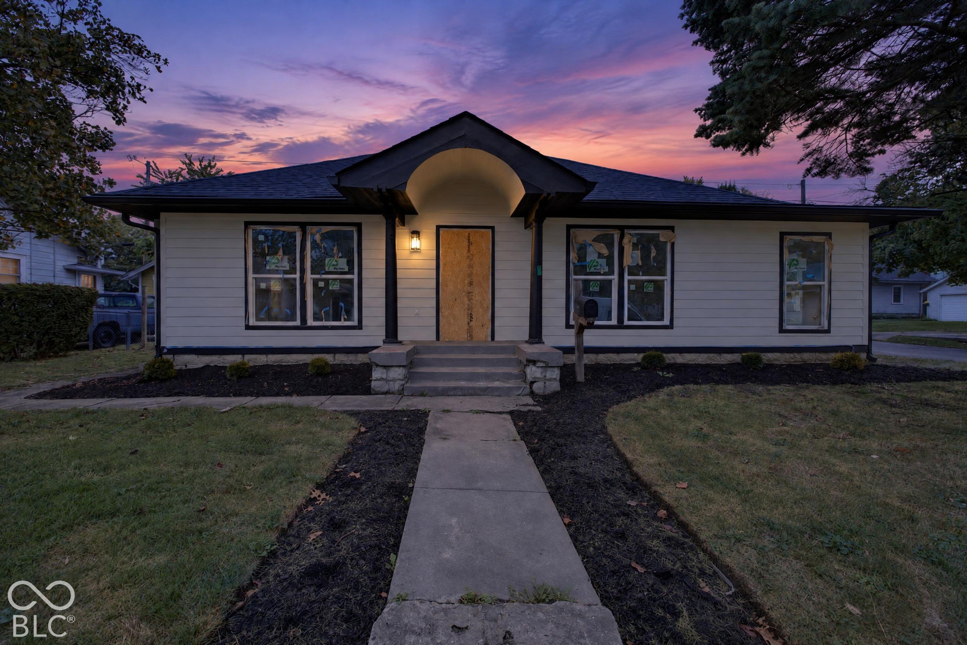 Virtually Altered - Light-colored siding exterior with dark trim accents