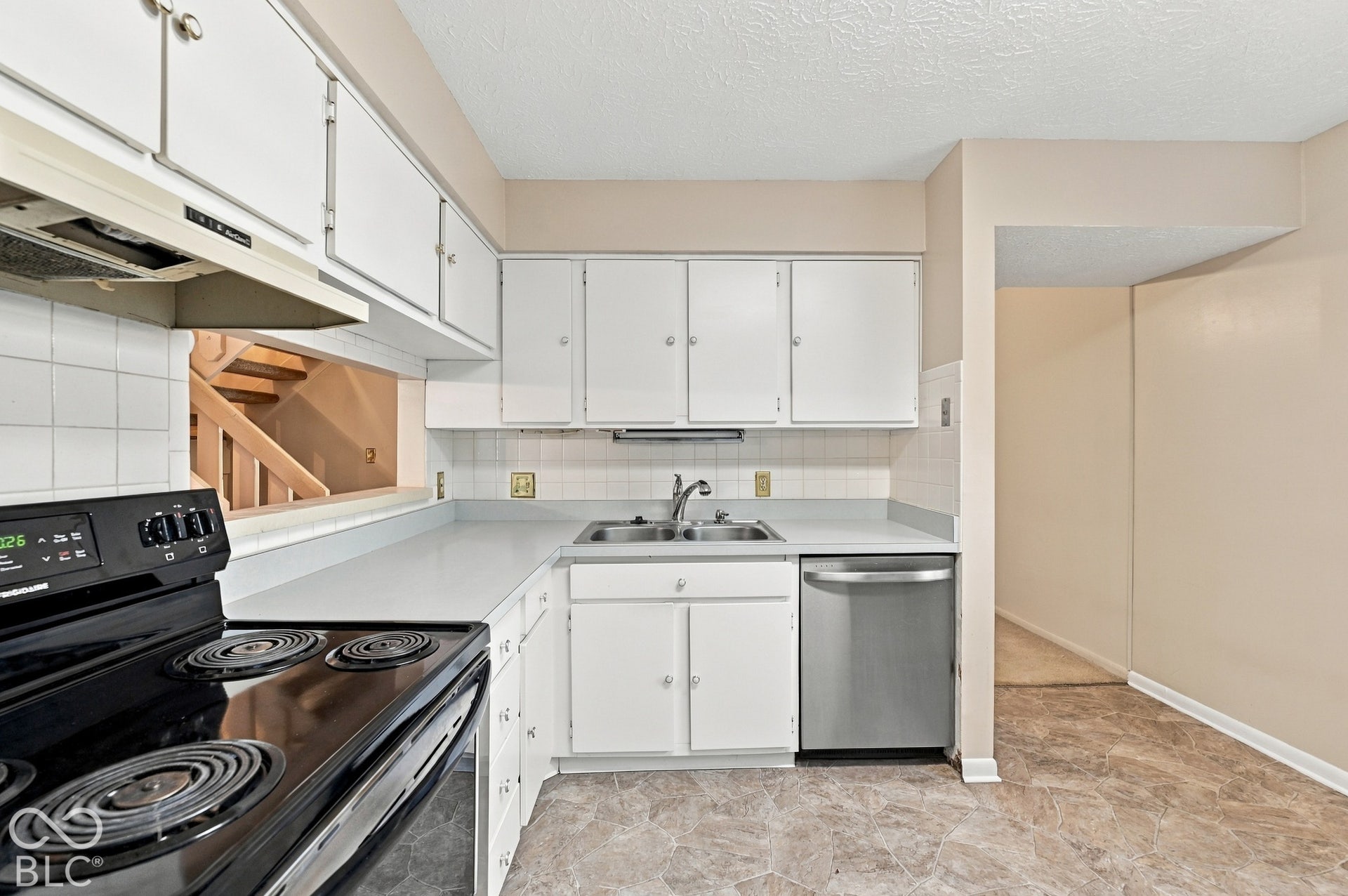 Kitchen featuring white cabinetry, a stainless steel electric range, and a stainless steel dishwasher