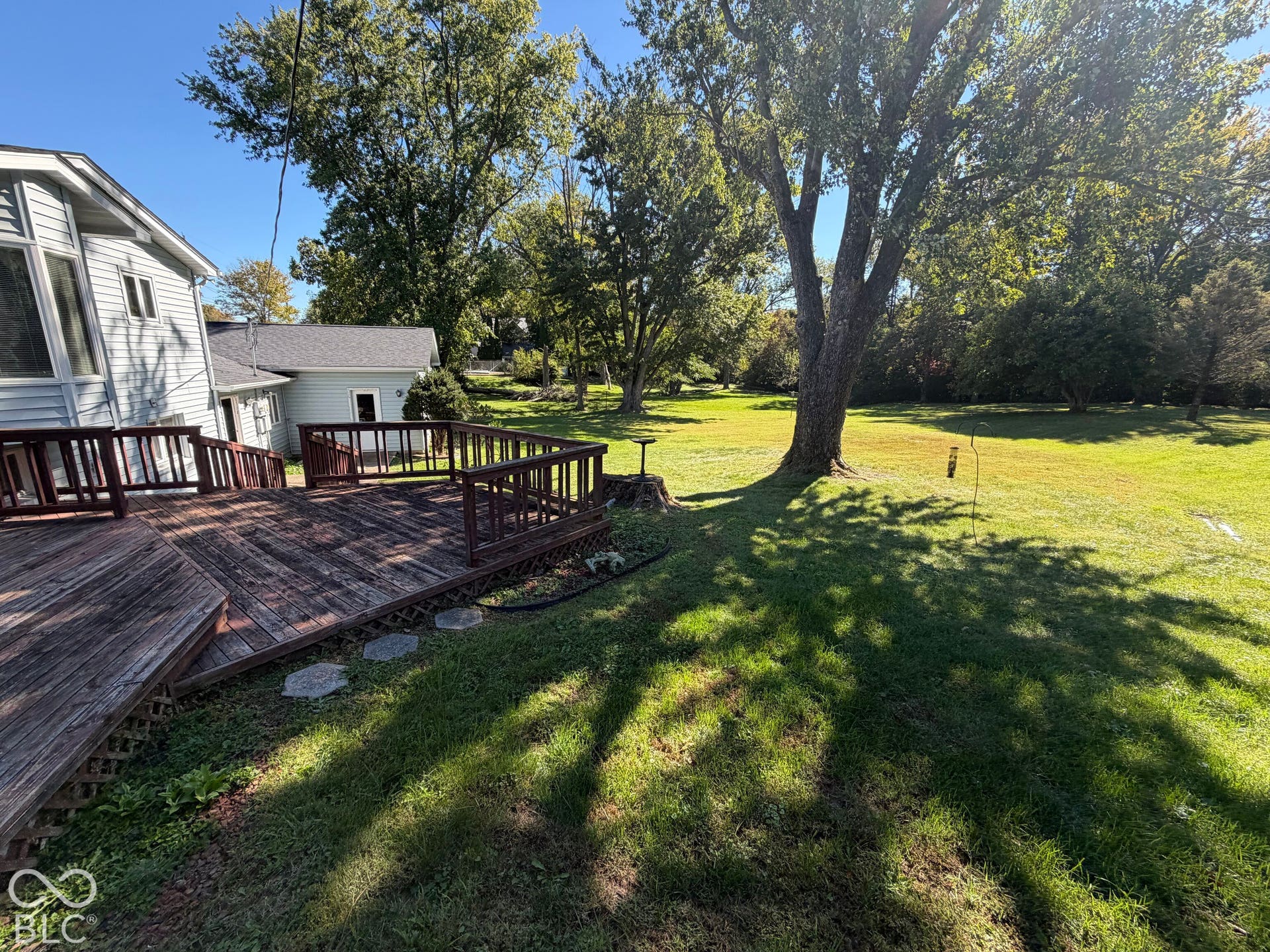 Expansive wooden deck with railing, providing outdoor living space