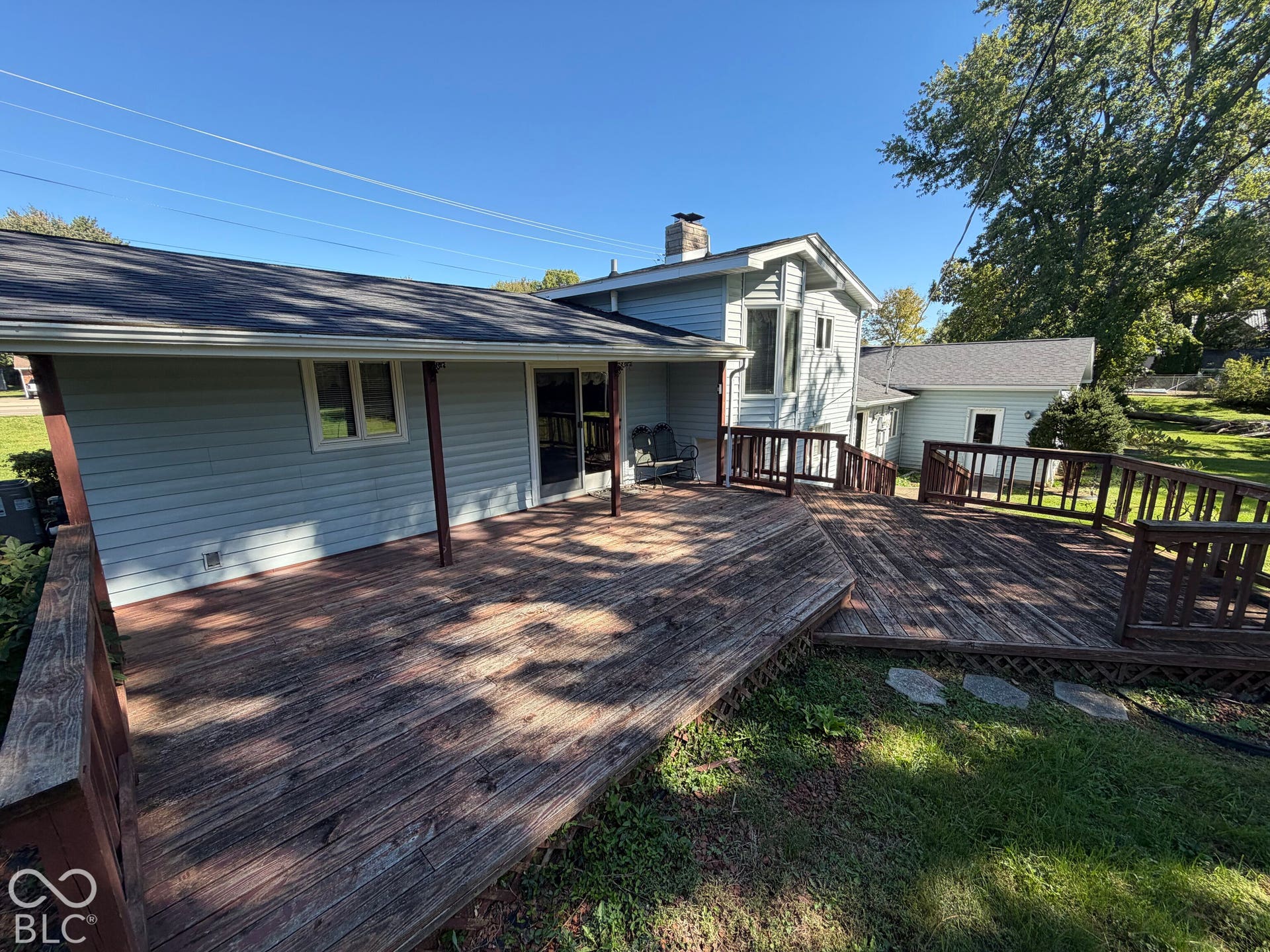 Expansive multi-level wooden deck with perimeter railings