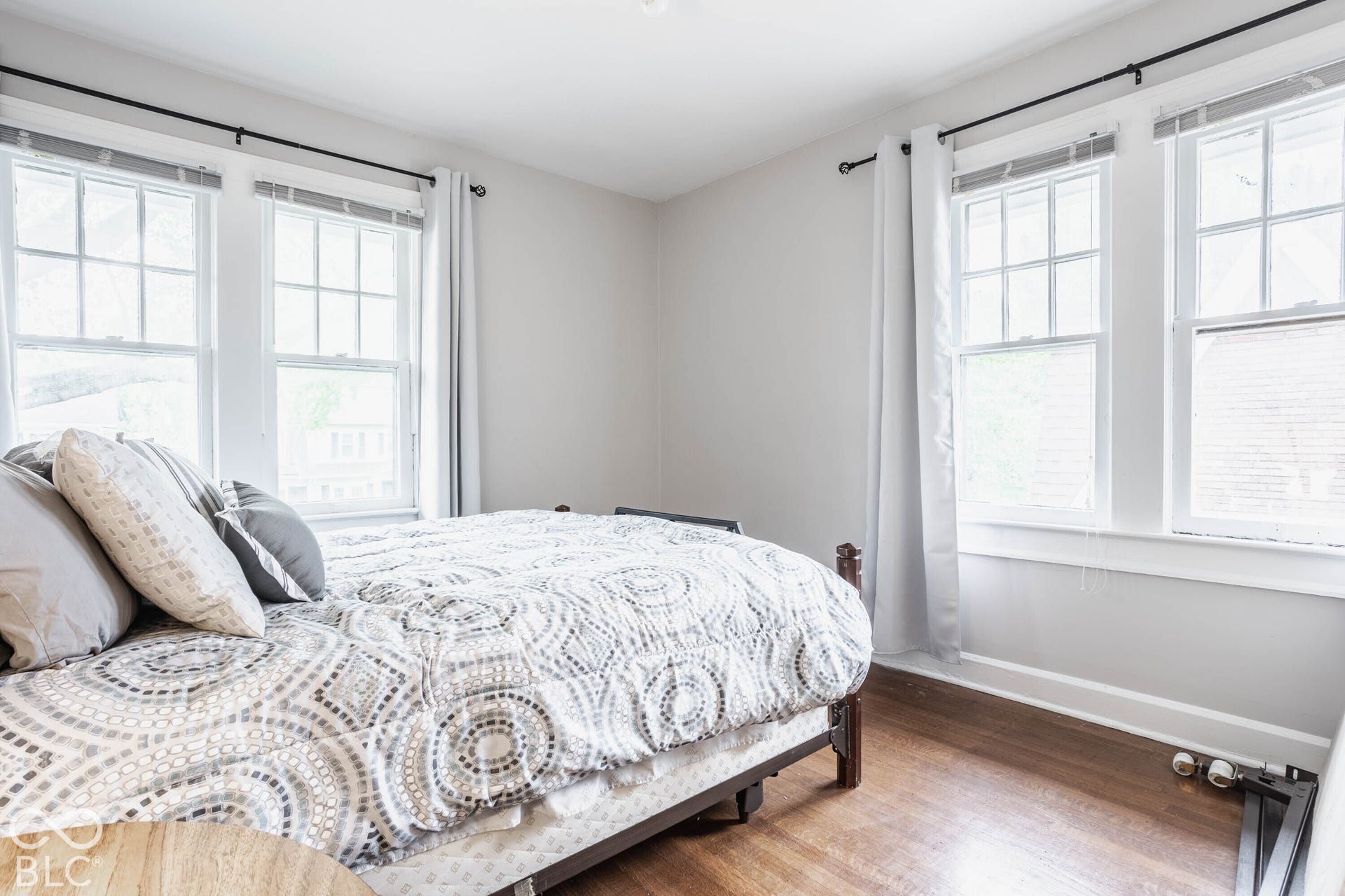 Neutral wall paint, wood-finish flooring, and multiple multi-pane windows