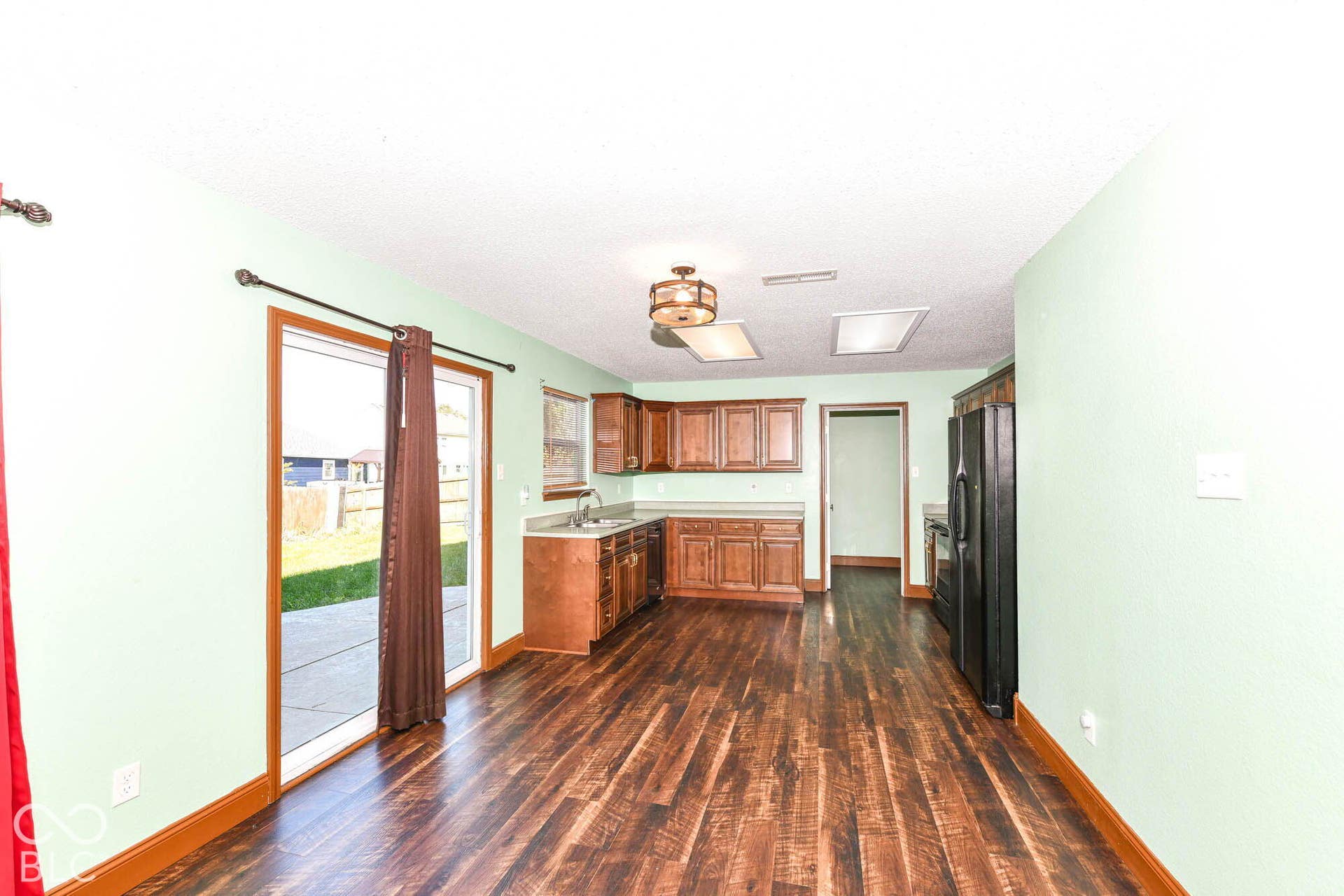 Wood-finish flooring, built-in cabinetry, recessed lighting, ceiling-mounted light fixture, and sliding glass door