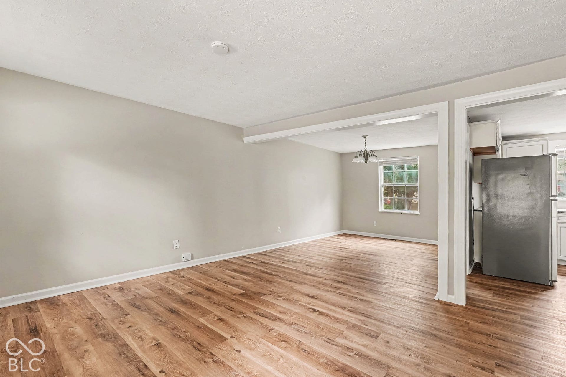 Wood-finish flooring throughout, complemented by light-toned wall paint and white trim