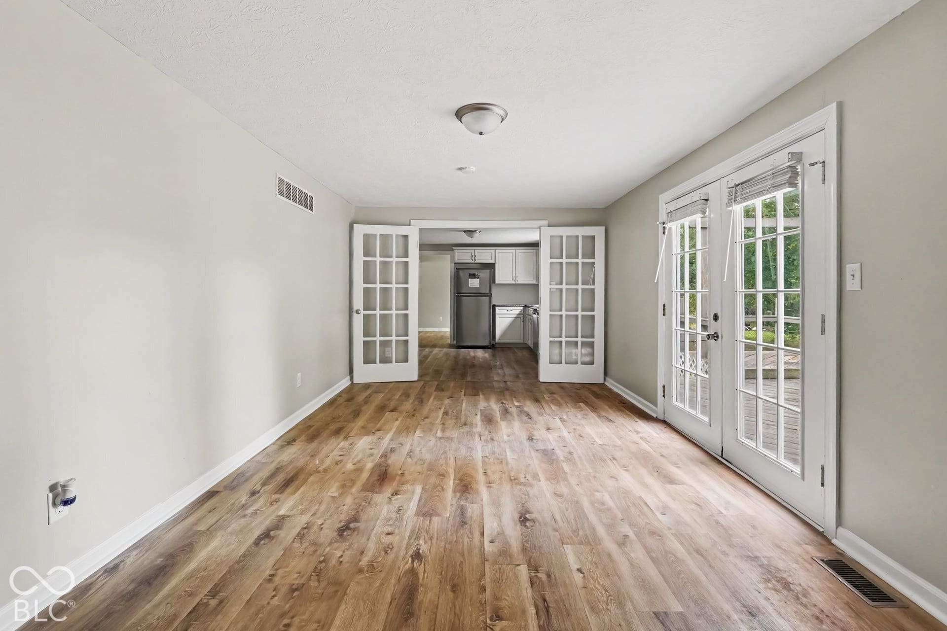 Wood-finish flooring throughout, paired with light gray walls