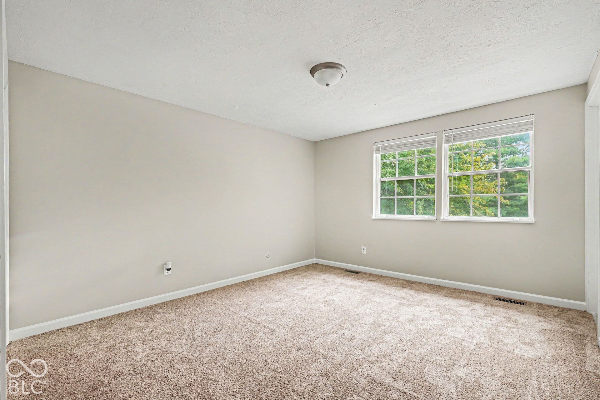 Neutral-toned walls complement carpeted flooring