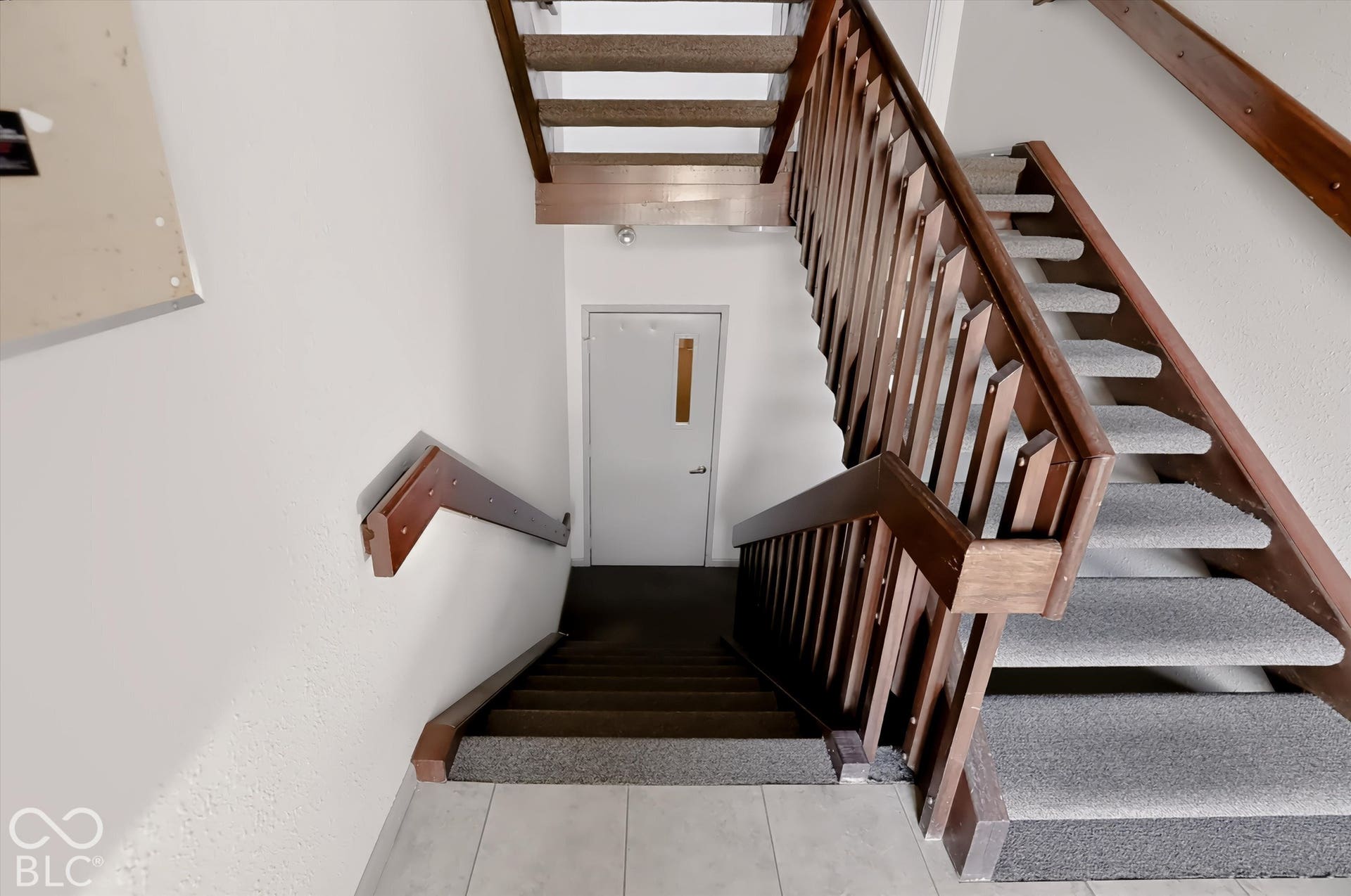 This is the foyer when you enter the building. Go down the stairs and the condo is the last one on the left.