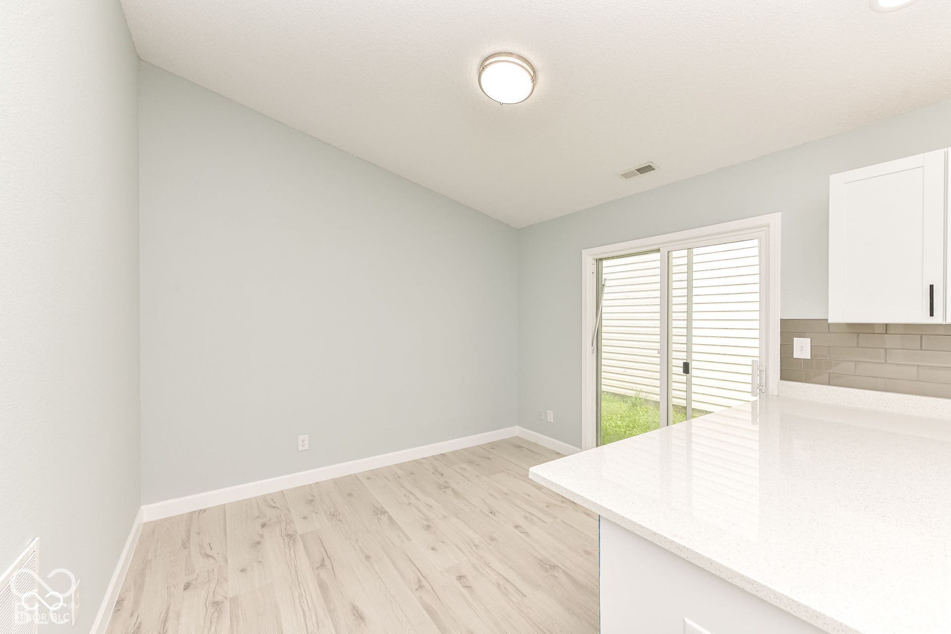Wood-finish flooring, light-toned walls, and a sliding glass door