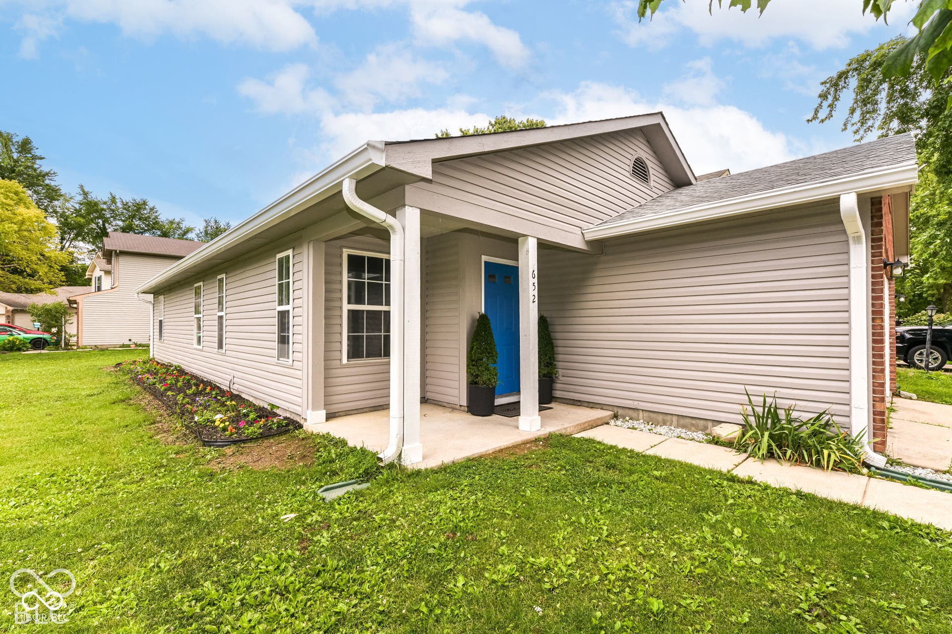 Exterior siding with a covered entry and a vibrant blue door