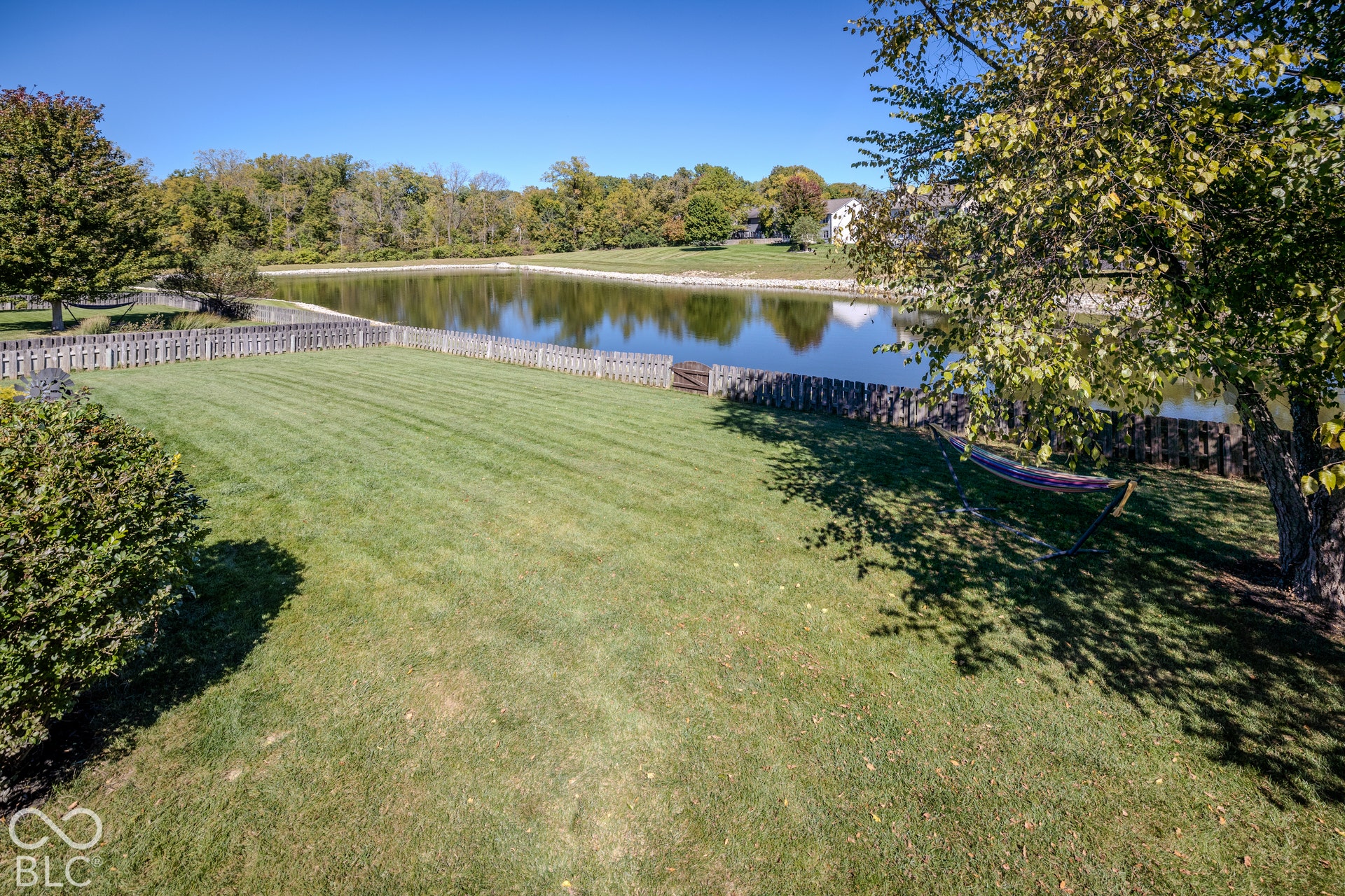 6416 Manchester Drive, Fishers, IN 46038 The fully fenced backyard offers relaxing pond views and lush landscaping.