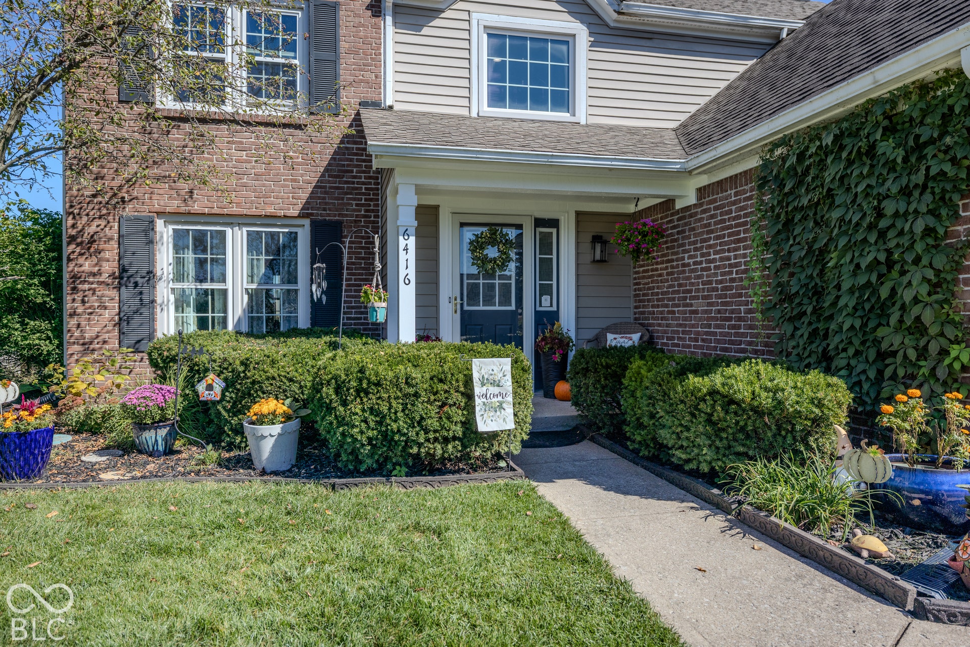 6416 Manchester Drive, Fishers, IN 46038 Inviting curb appeal with lush landscaping and a covered front porch that creates a warm first impression.