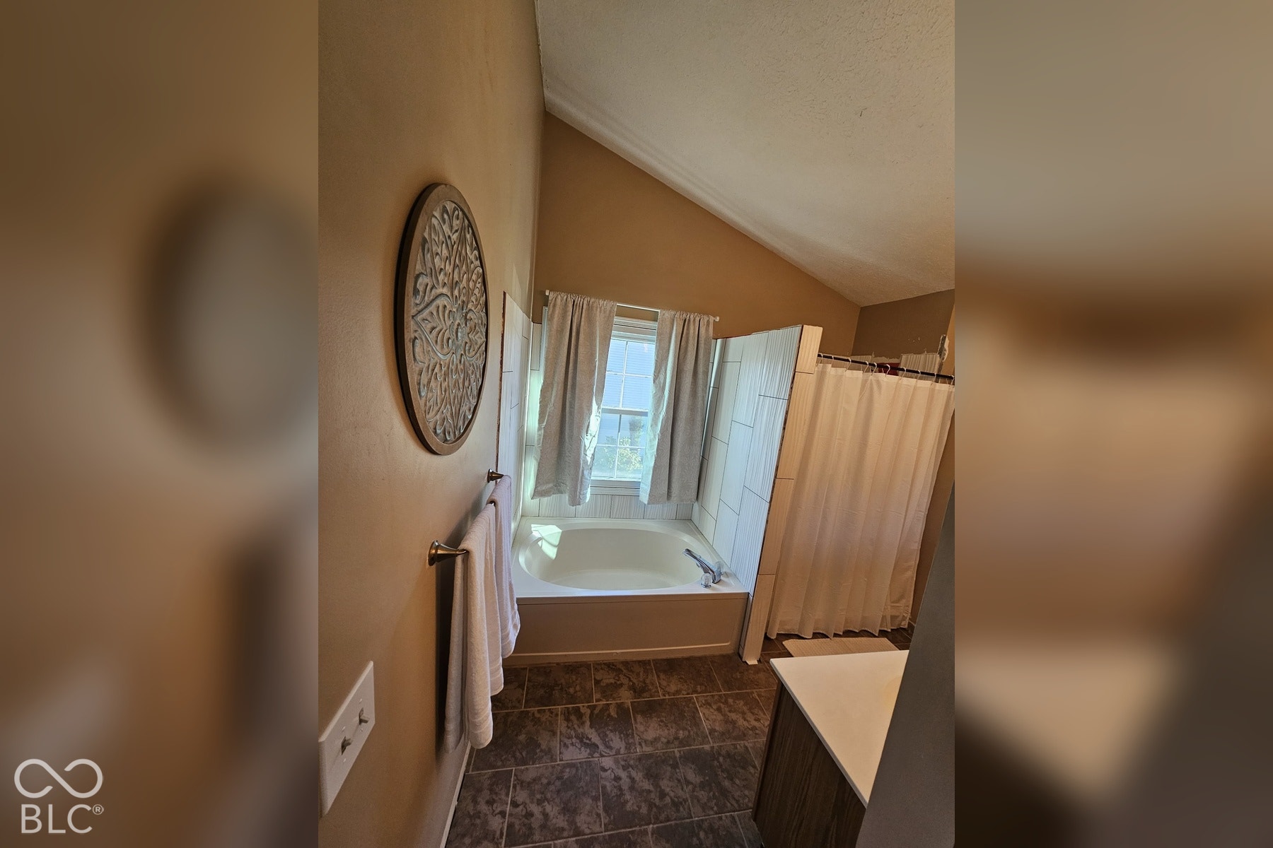 6416 Manchester Drive, Fishers, IN 46038 The vaulted ceiling gives a sense of spaciousness to the primary bath along with a large window to let in natural light.