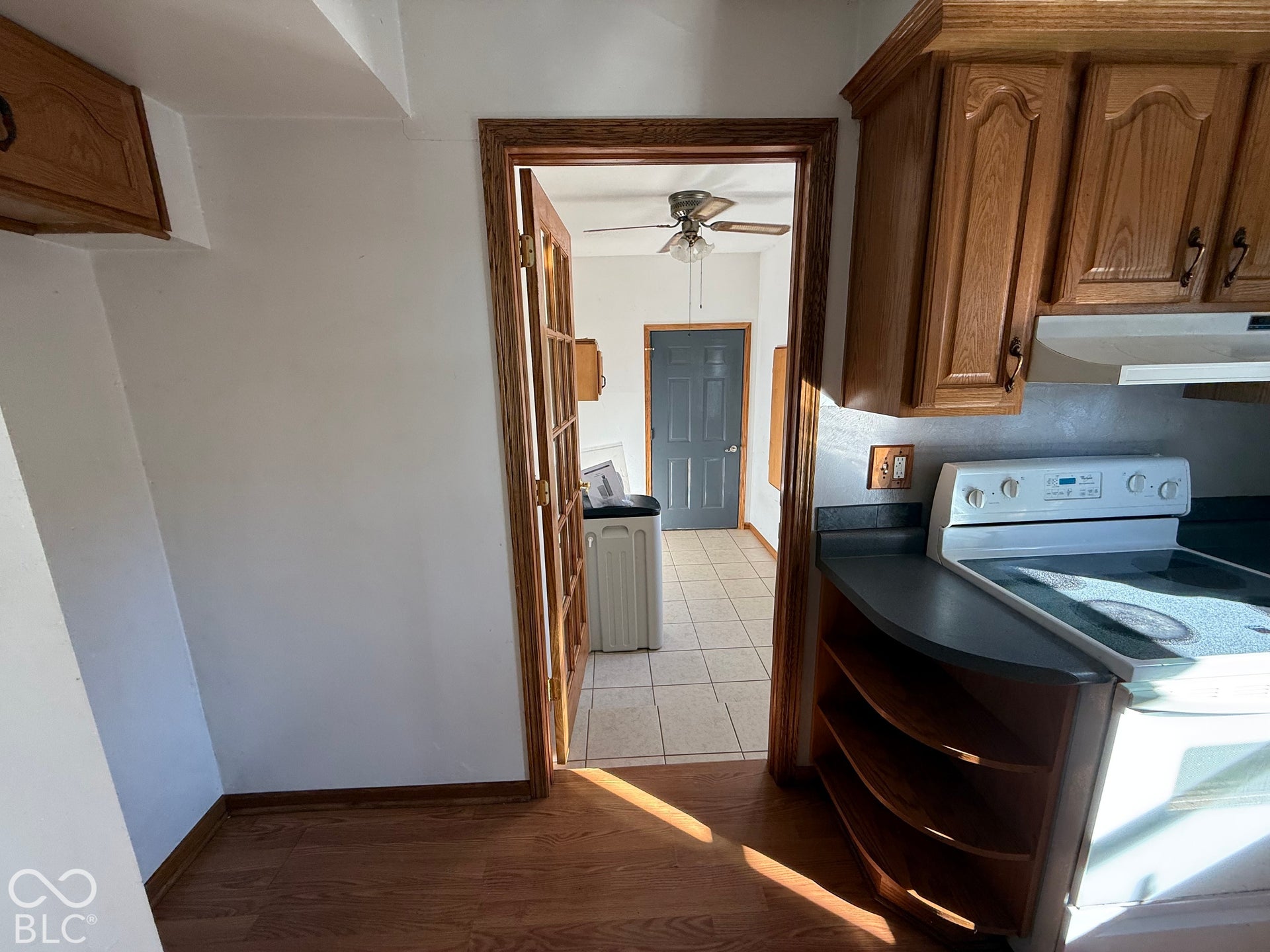 Wood-finish flooring, wood cabinetry, and a built-in electric range
