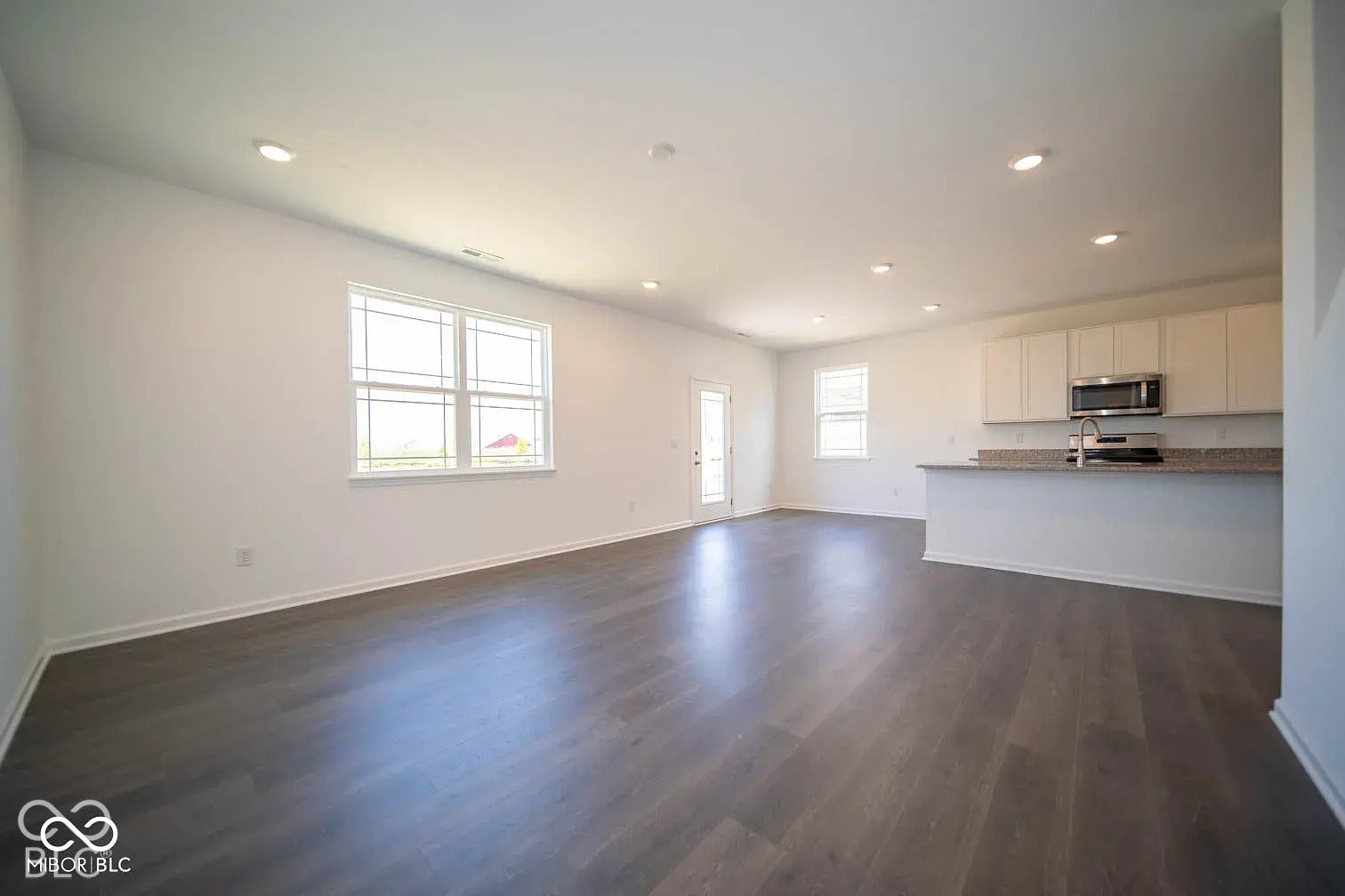 5778 Aleppo Lane, Greenwood, IN 46143 Spacious open-concept interior featuring wood-finish flooring, recessed lighting, and white walls