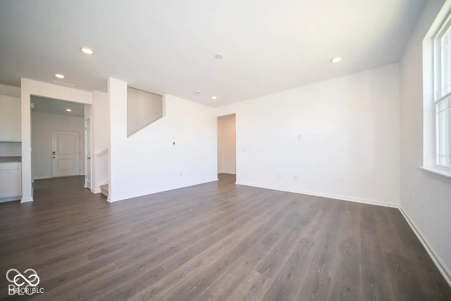 5778 Aleppo Lane, Greenwood, IN 46143 Recessed lighting, wood-finish flooring, white walls, and a window with white trim