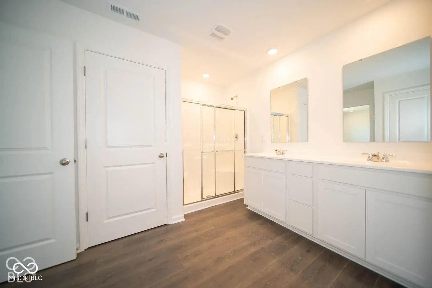 5778 Aleppo Lane, Greenwood, IN 46143 Dual vanity with white cabinetry, two undermount sinks, and two framed mirrors