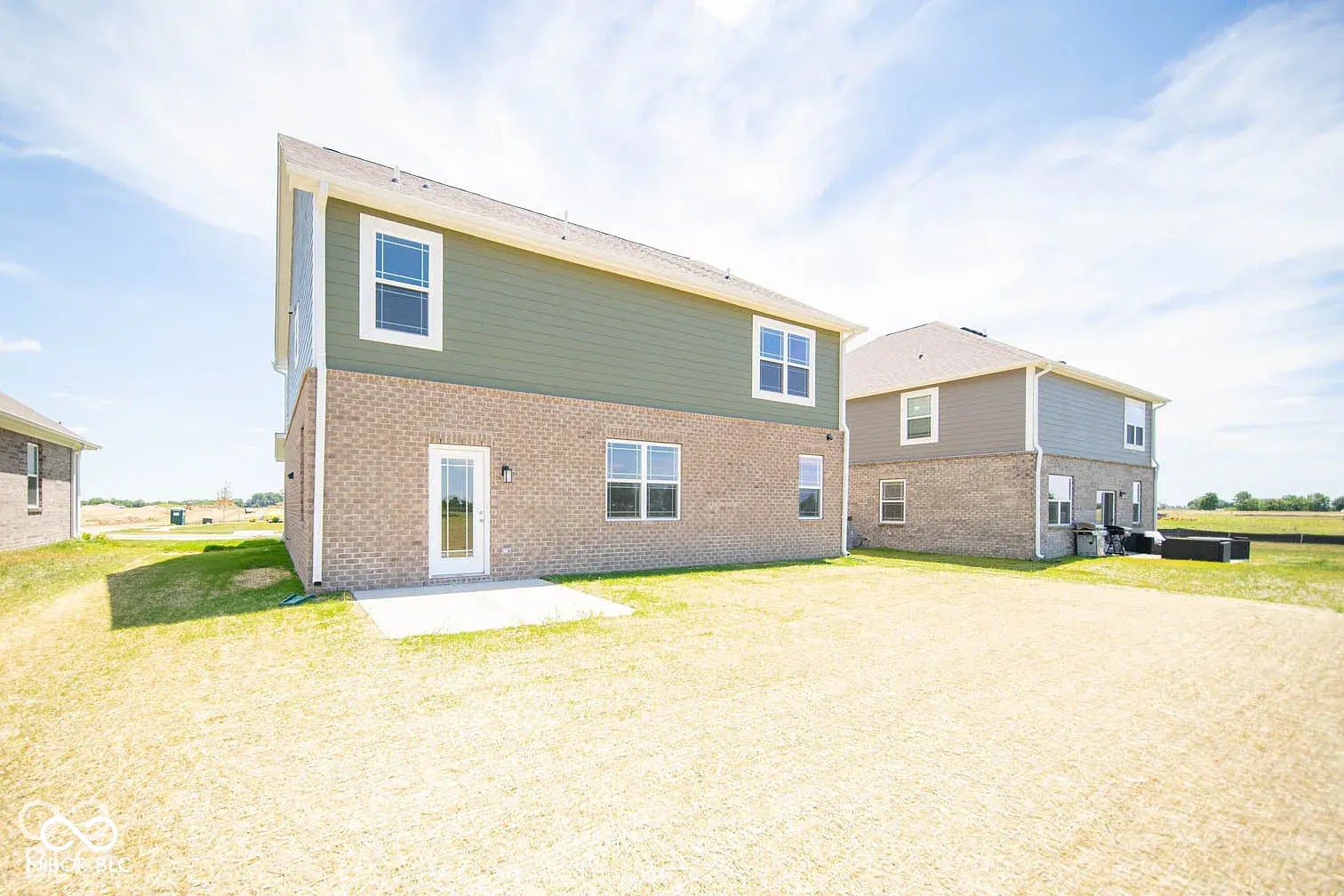5778 Aleppo Lane, Greenwood, IN 46143 Two-story exterior with brick and siding, featuring multiple windows and a rear patio