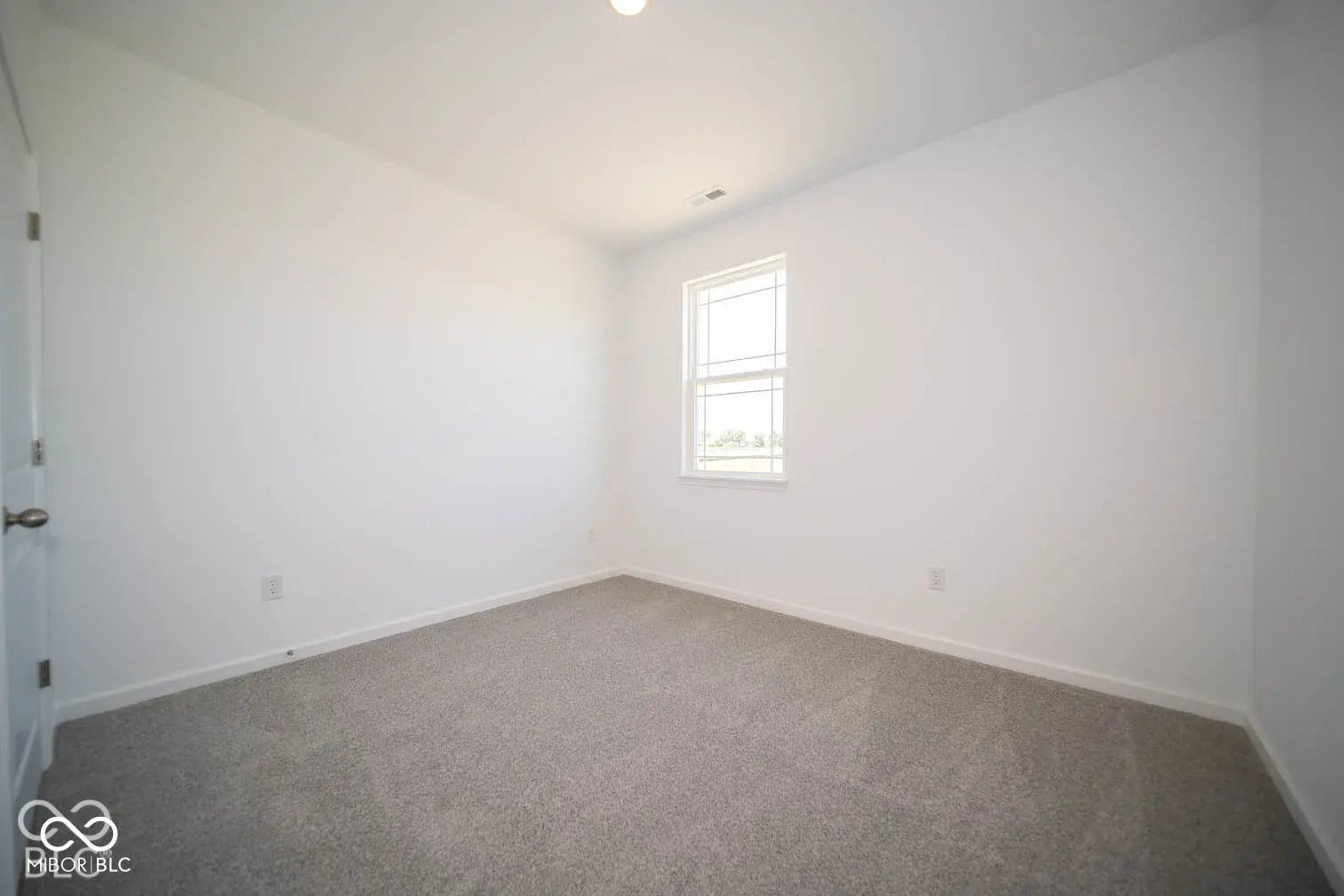 5778 Aleppo Lane, Greenwood, IN 46143 Neutral-toned carpeting, white walls, and a window with a white frame