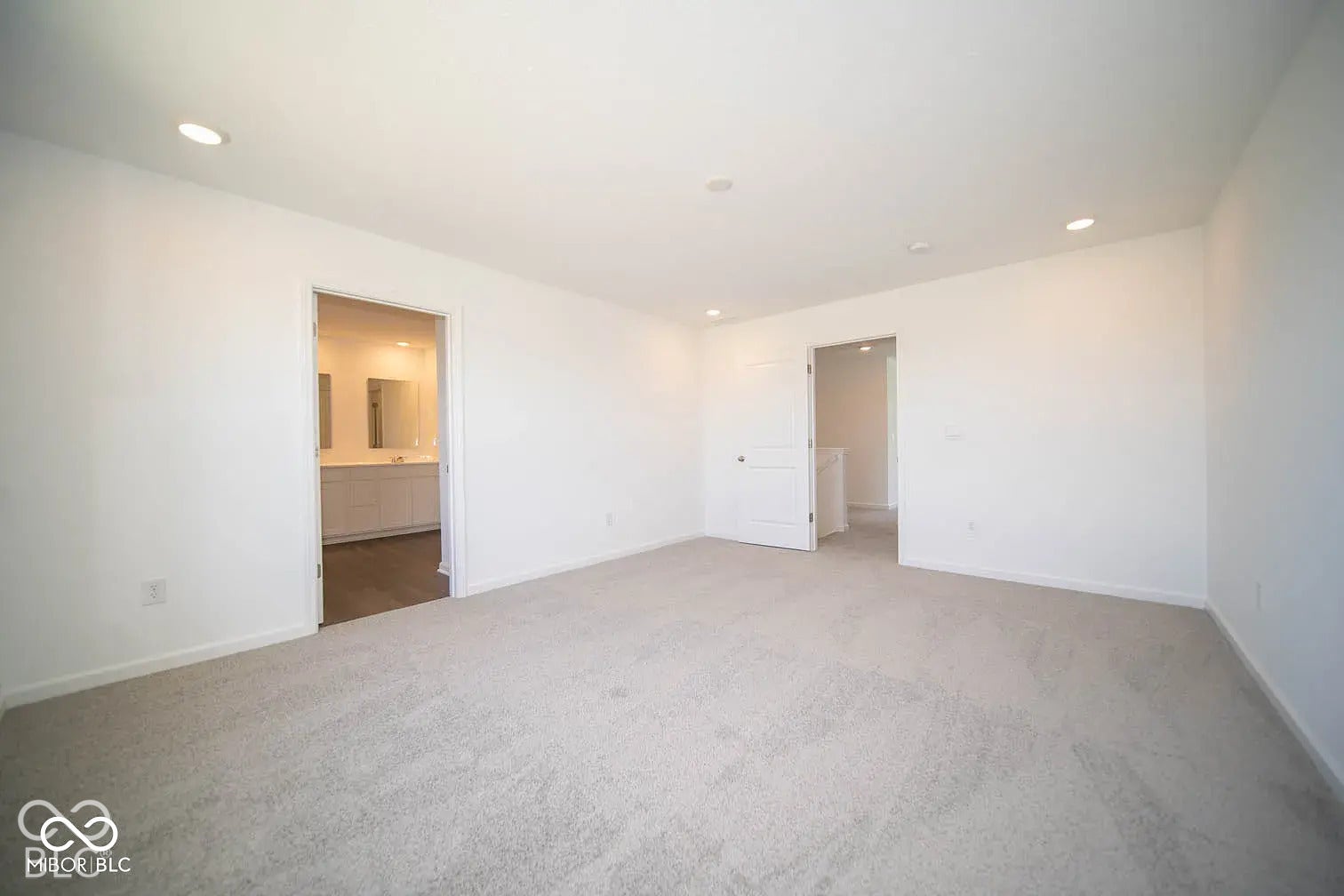 5778 Aleppo Lane, Greenwood, IN 46143 Recessed lighting illuminates a spacious room featuring light-toned carpeting