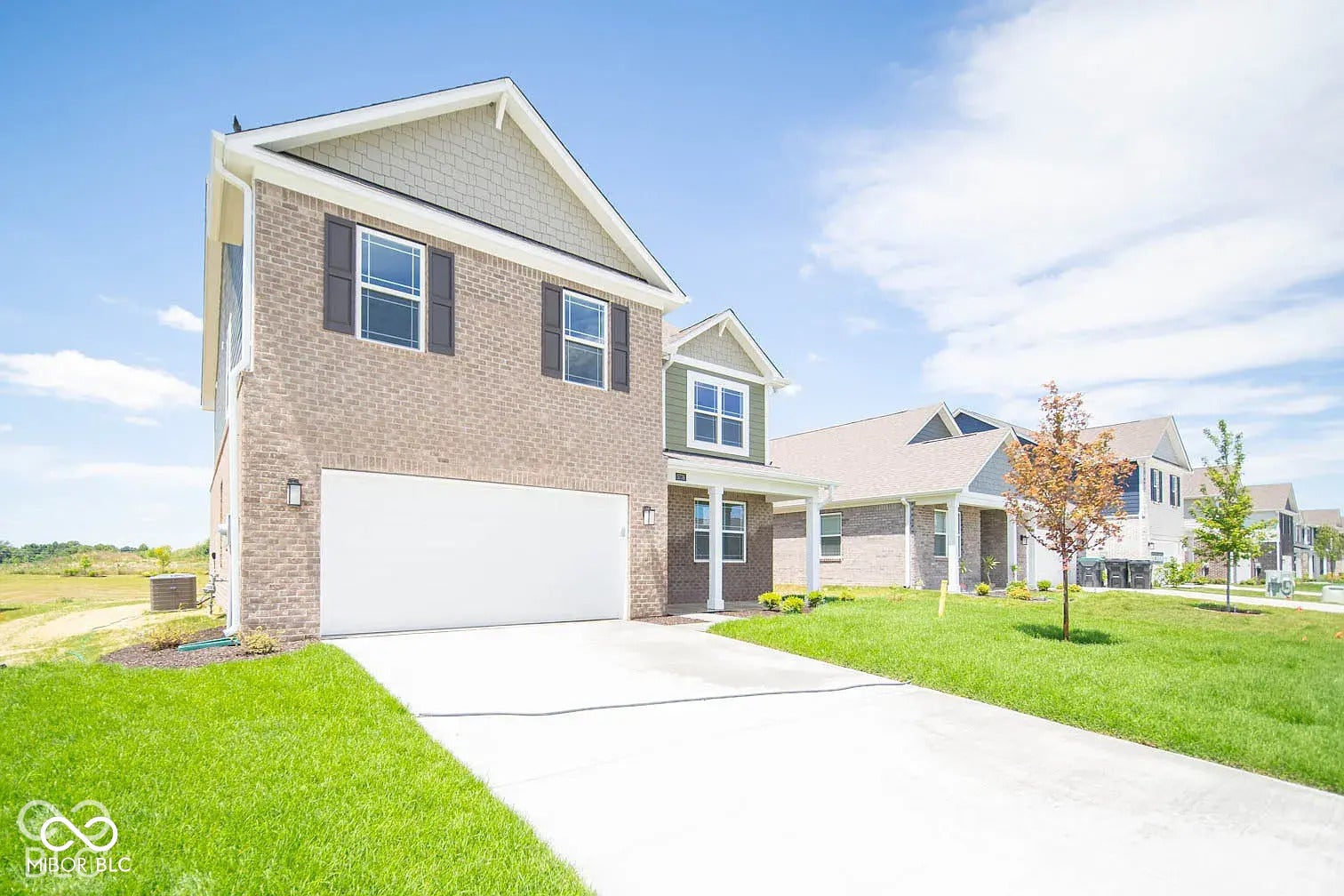 5778 Aleppo Lane, Greenwood, IN 46143 Brick exterior with complementary siding accents, attached garage, and a concrete driveway
