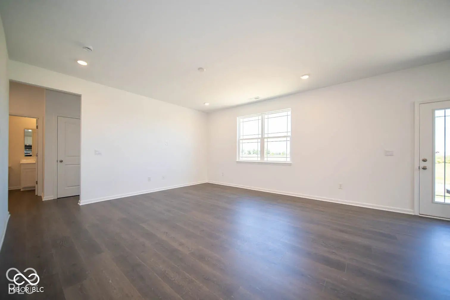 5778 Aleppo Lane, Greenwood, IN 46143 Expansive living area featuring wood-finish flooring, recessed lighting, and white walls