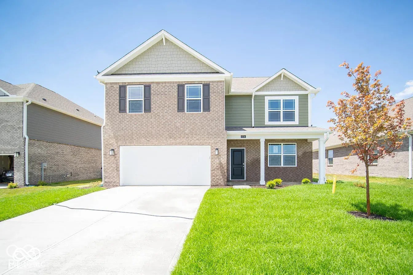 5778 Aleppo Lane, Greenwood, IN 46143 Two-story residence featuring brick and siding exterior, an attached two-car garage, a covered front porch, and a concrete driveway