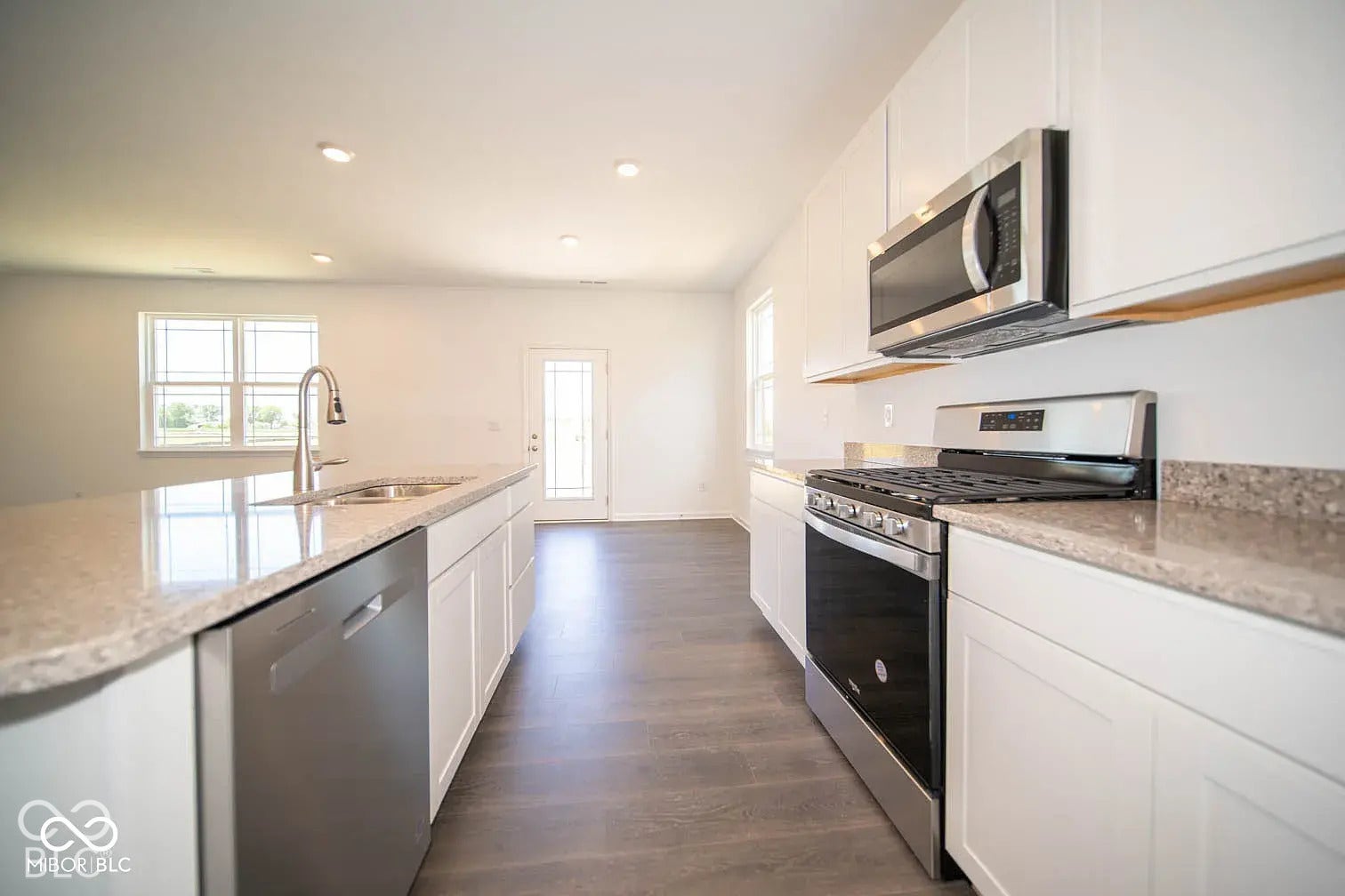 5778 Aleppo Lane, Greenwood, IN 46143 White cabinetry, wood-finish flooring, stainless steel appliances, granite-style countertops, and recessed lighting