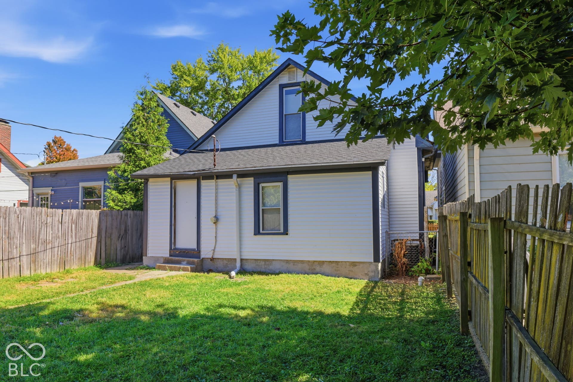 Expansive grassy yard with wood fencing