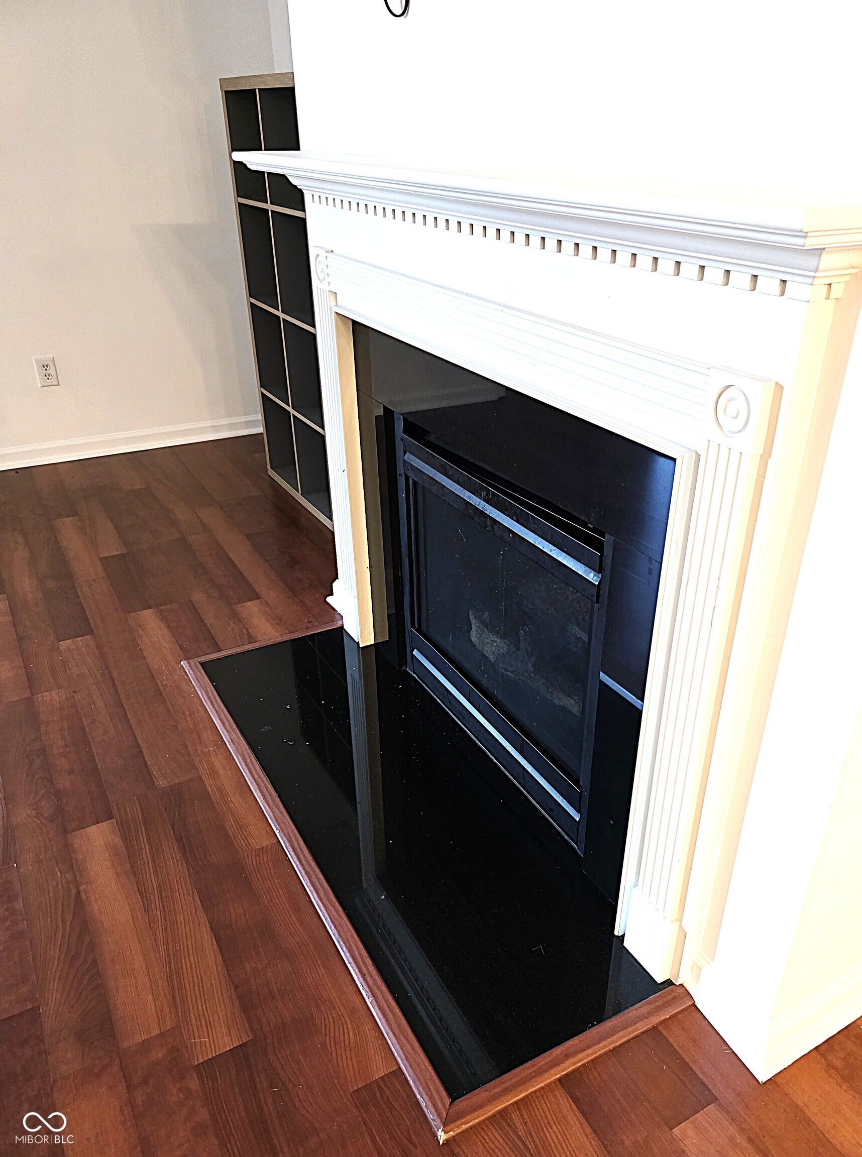 Fireplace with a white mantel and black hearth