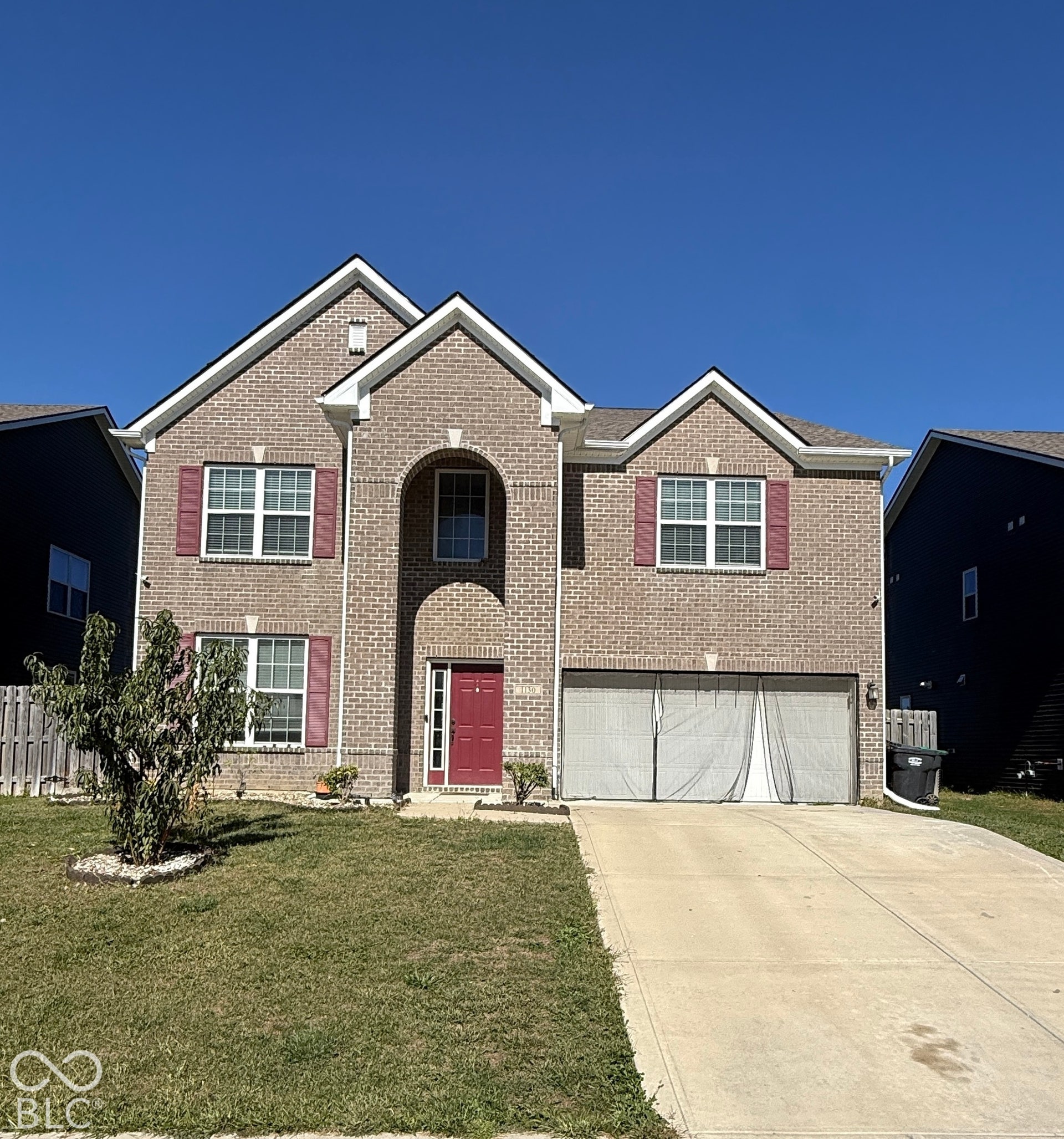 Brick two-story exterior with an arched entryway