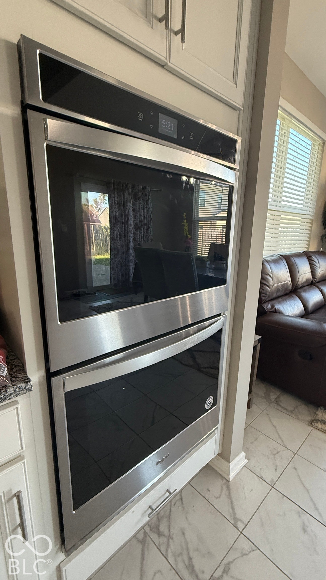 Stainless steel double wall ovens integrated into custom cabinetry