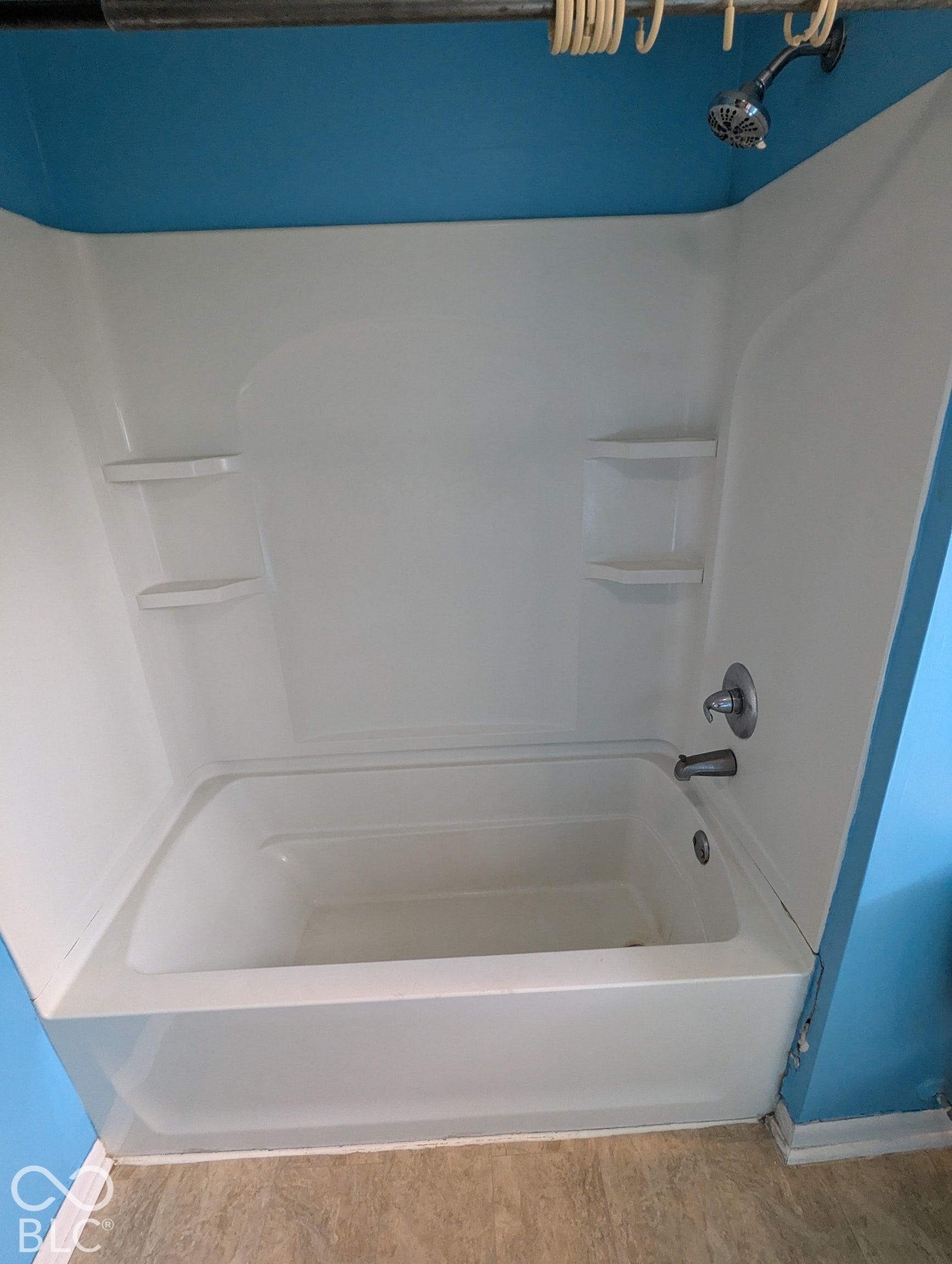 364 Robbins Drive, Greenwood, IN 46142 White bathtub with integrated shower, chrome fixtures, and built-in shelving