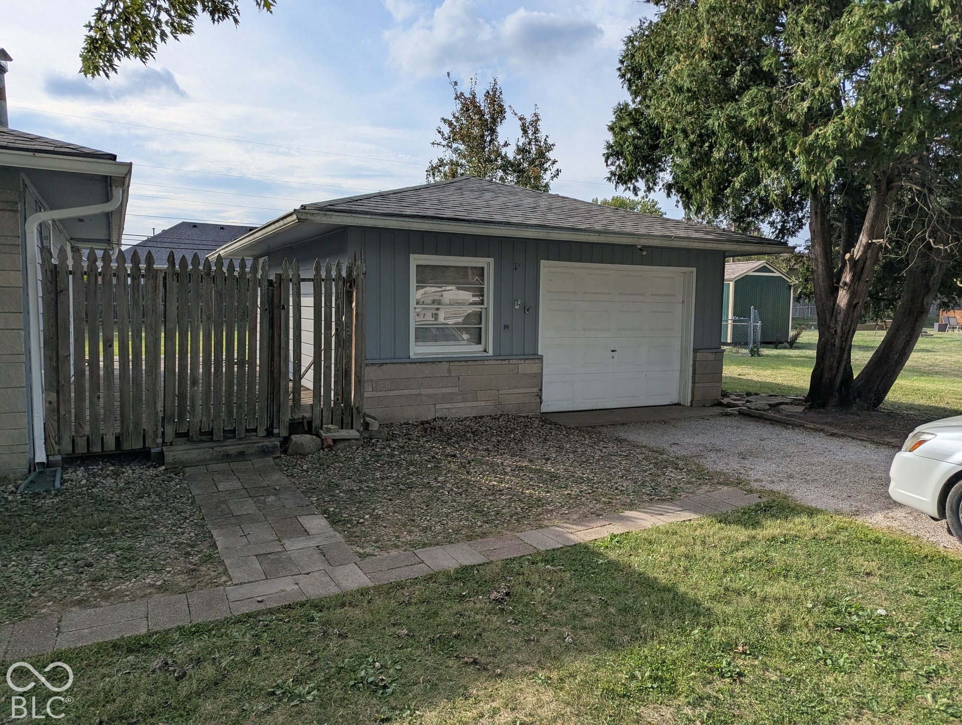 364 Robbins Drive, Greenwood, IN 46142 Detached garage with a paneled door, light blue siding, and a stone-clad foundation