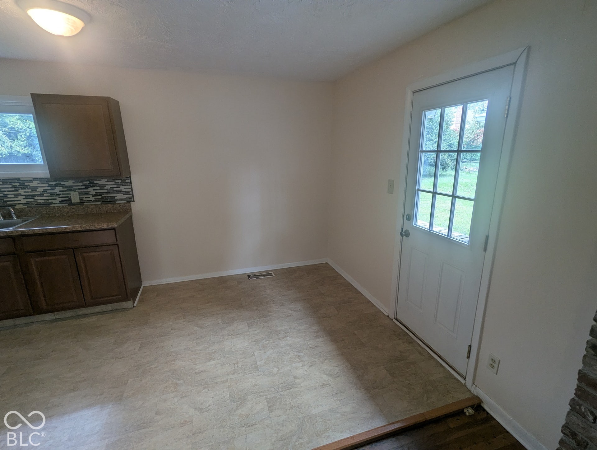 364 Robbins Drive, Greenwood, IN 46142 The eat-in kitchen has a dining area for a table and is open to the living room. A multi-panel glass door has door leads to wood deck and garage.