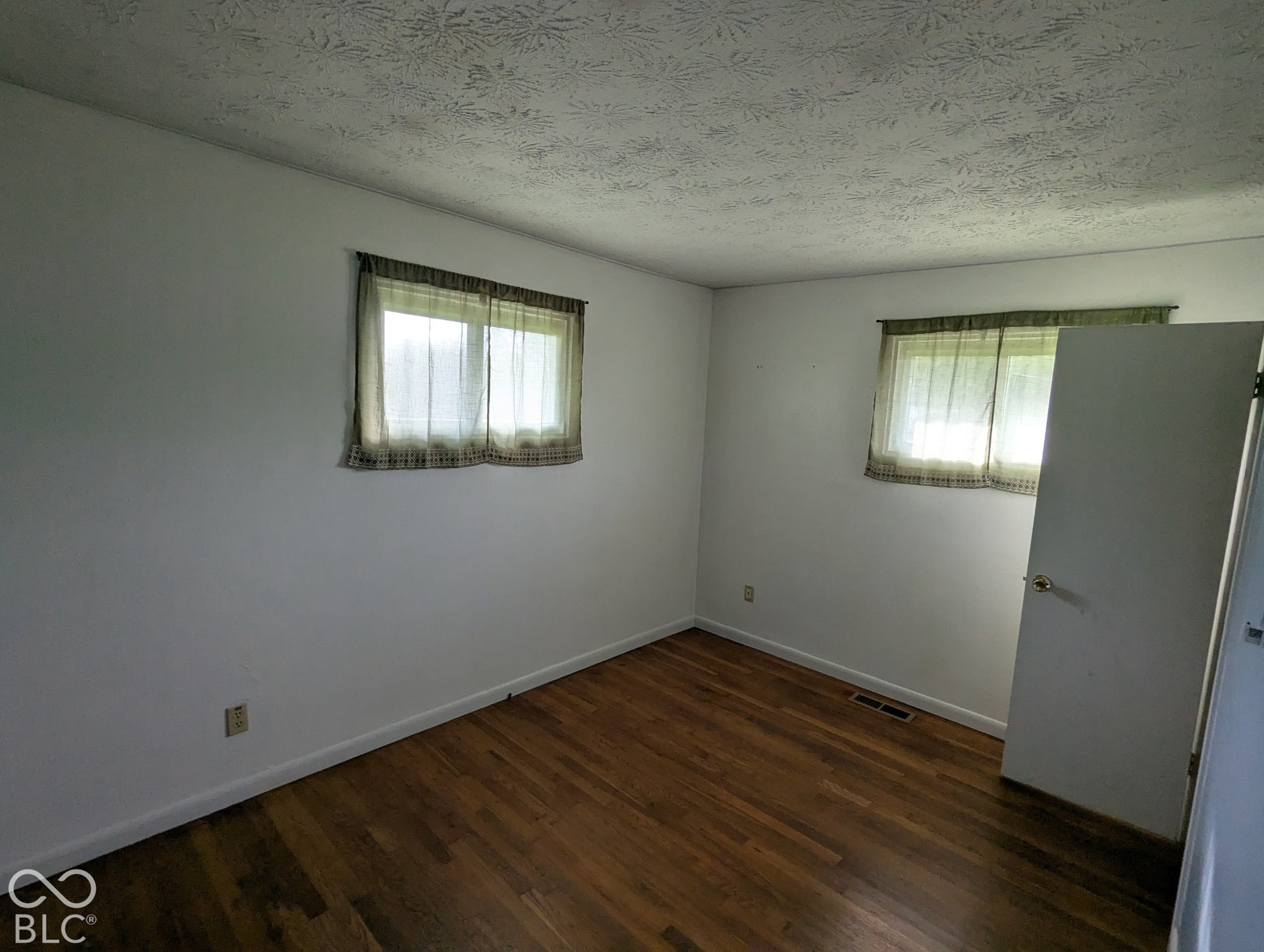 364 Robbins Drive, Greenwood, IN 46142 Hardwood flooring, two windows, and a ceiling with a textured finish
