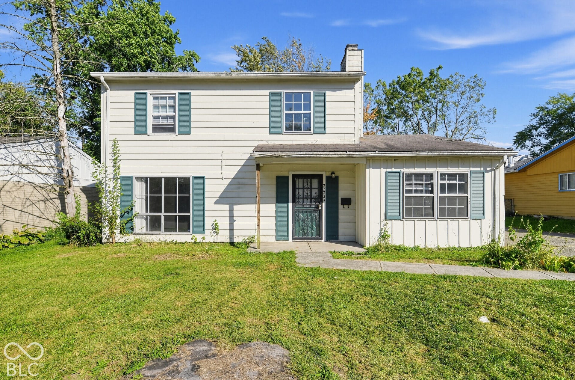 3733 Ireland Drive, Indianapolis, IN 46235 Two-story siding exterior with a partial porch and a prominent chimney