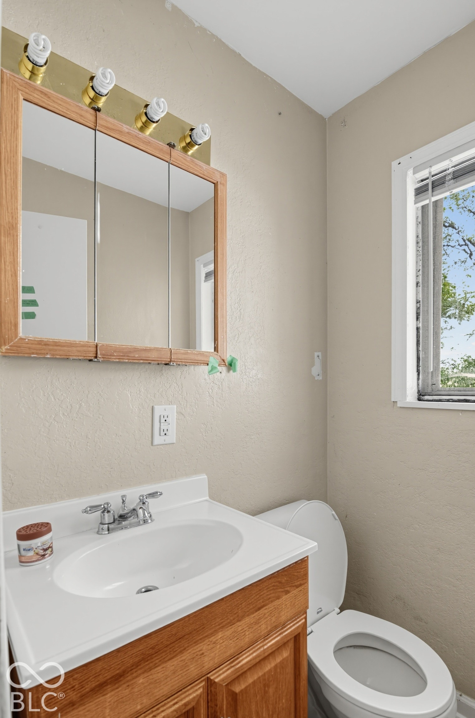 3733 Ireland Drive, Indianapolis, IN 46235 Wood-finish vanity with an integrated white sink and chrome faucet