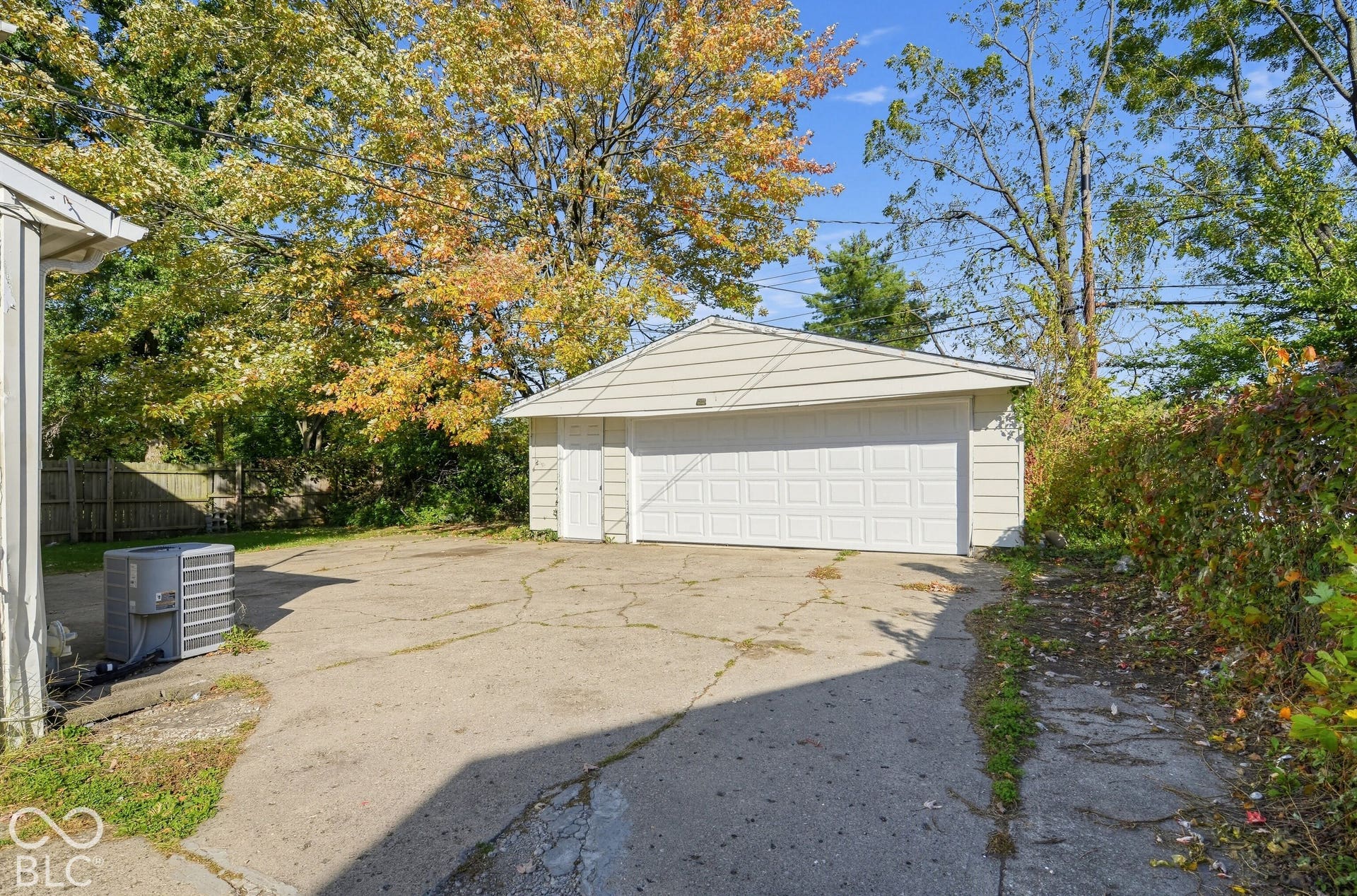 3733 Ireland Drive, Indianapolis, IN 46235 Detached garage with a paneled door and side entry, featuring vinyl siding