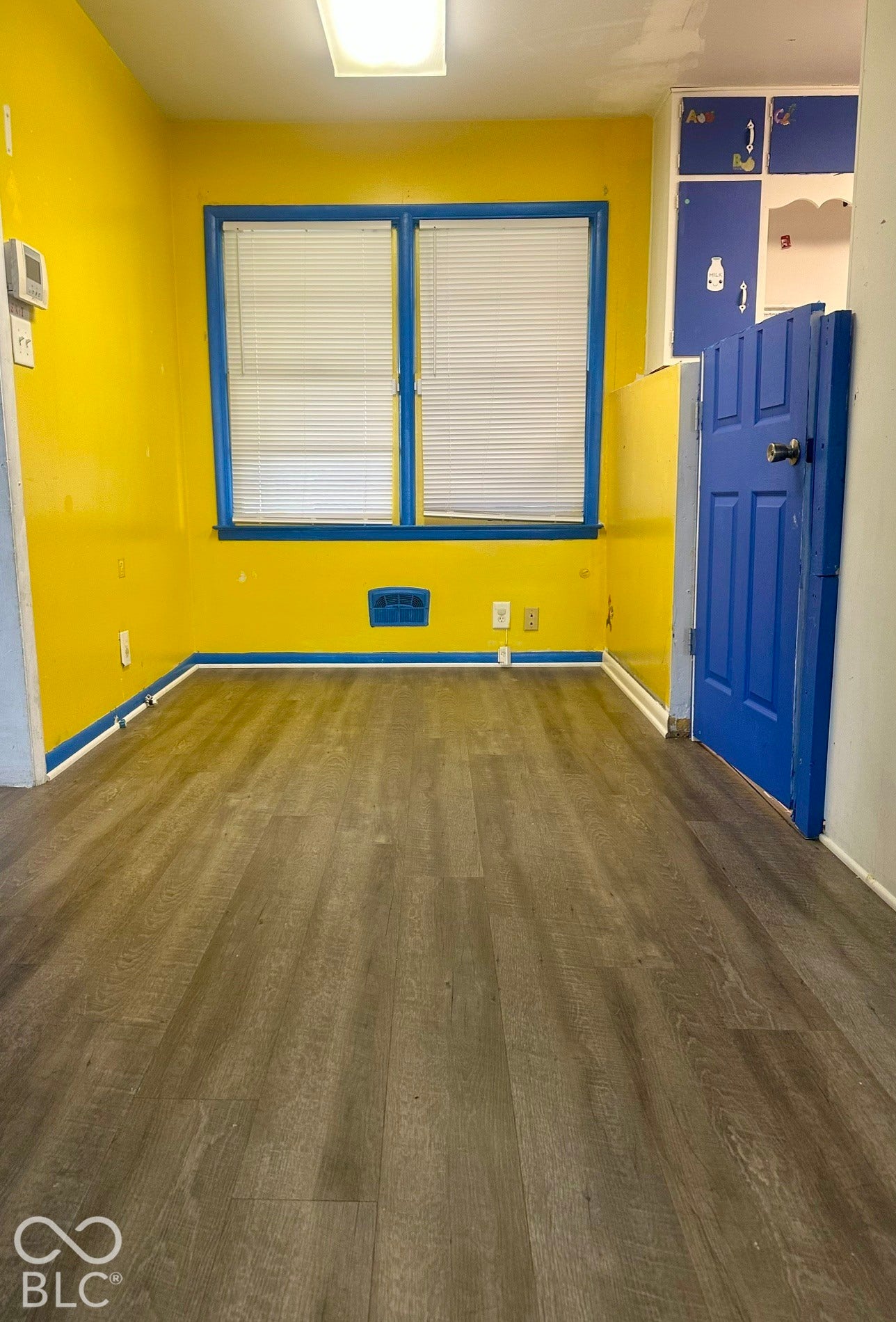 Extended Area off of main room and open to the kitchen area with a half wall/door separating the spaces