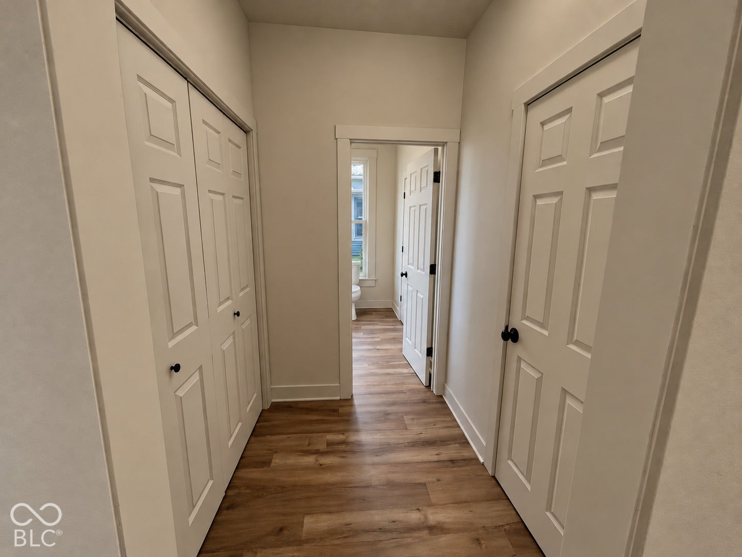 Wood-finish flooring throughout the hallway