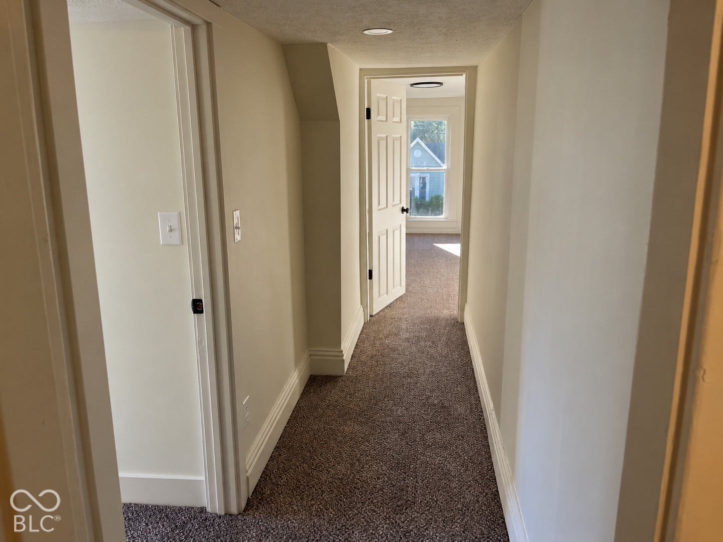 Hallway featuring carpet flooring and white trim
