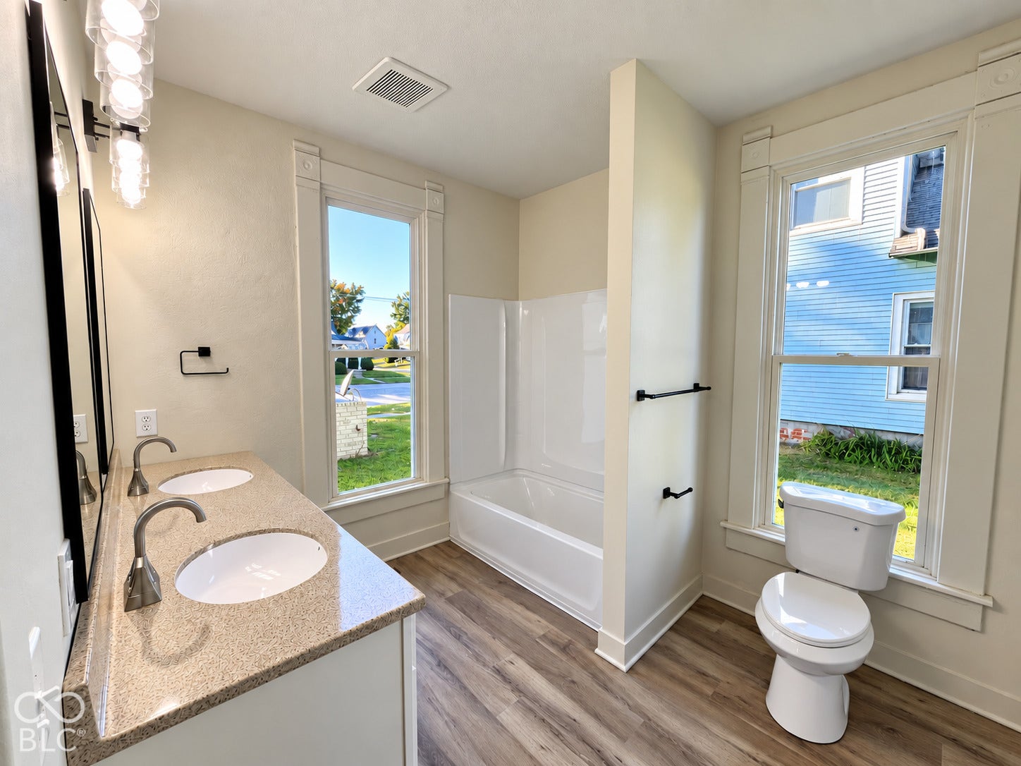 Dual vanity with a speckled countertop, two undermount sinks, and contemporary faucets